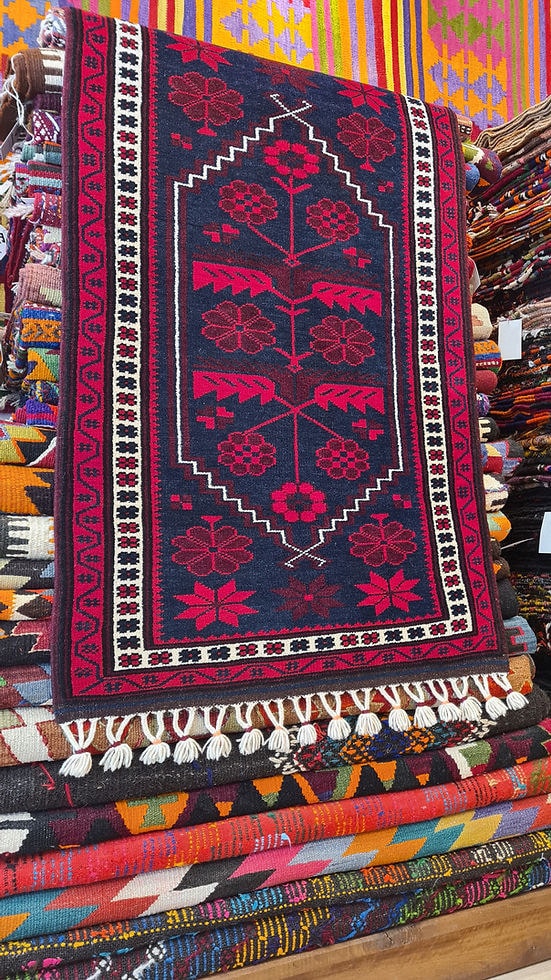 vintage balikesir yagcibedir floral carpet in red and navy hues inside our rug store in NYC