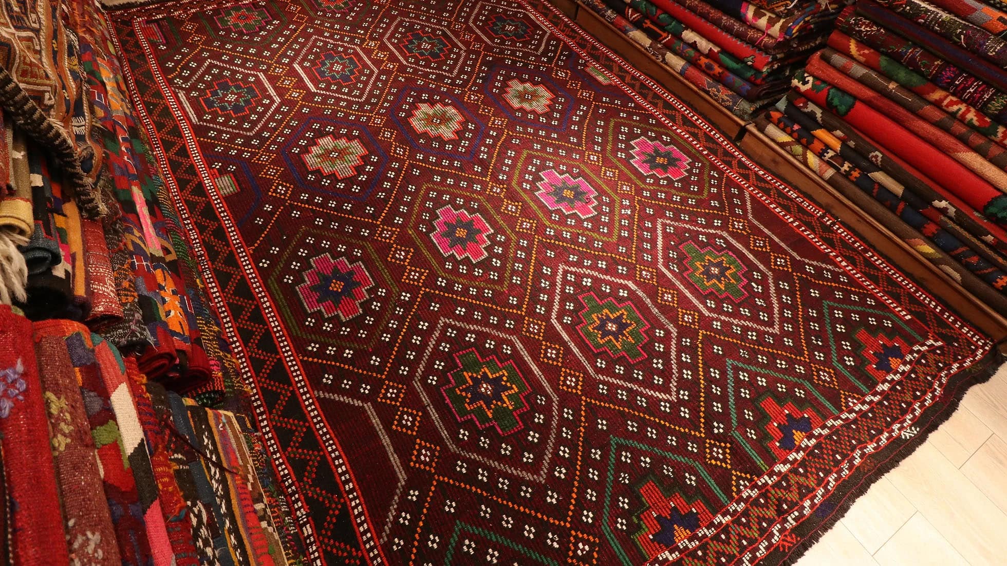 gorgeous red oriental Kurdish kilim rug in pink floral patterns by Kilim Couture New York