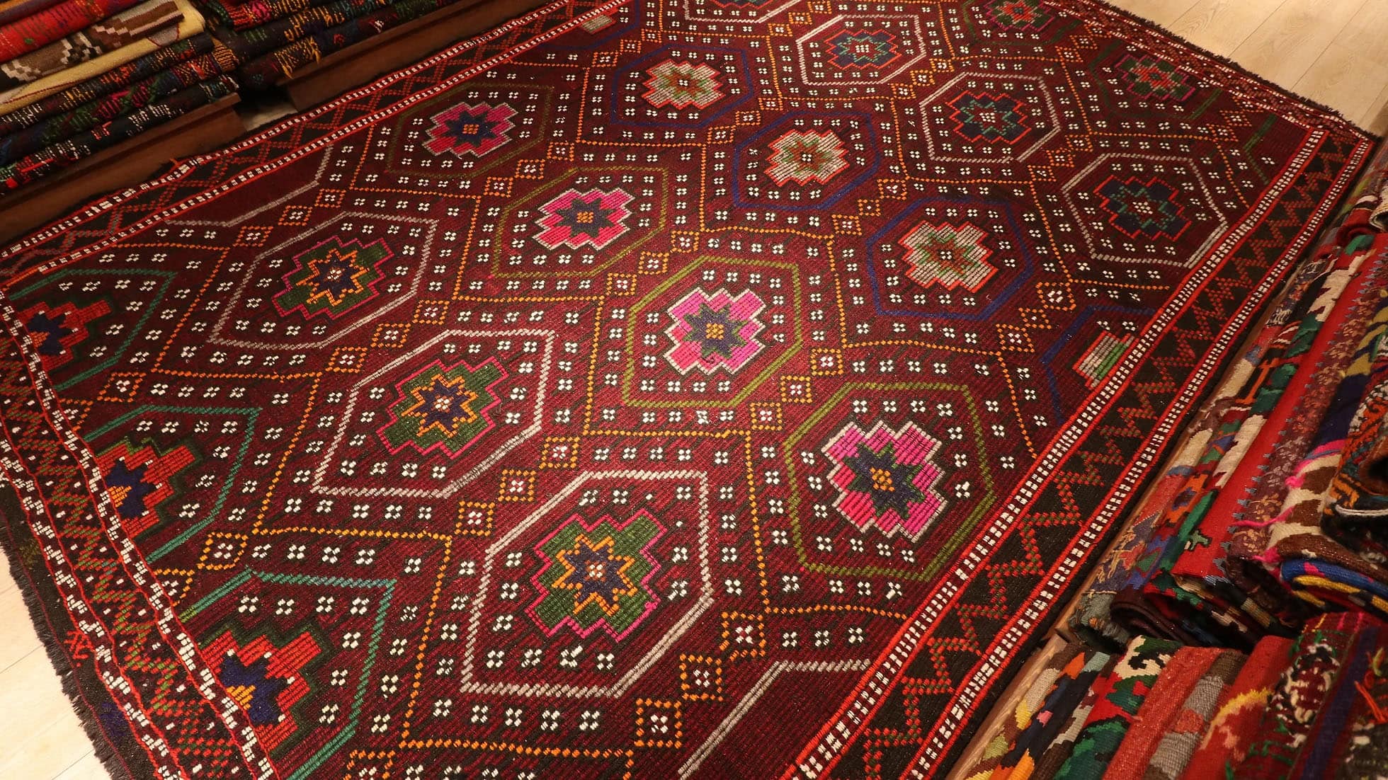gorgeous red oriental Kurdish kilim rug in pink floral patterns by Kilim Couture New York