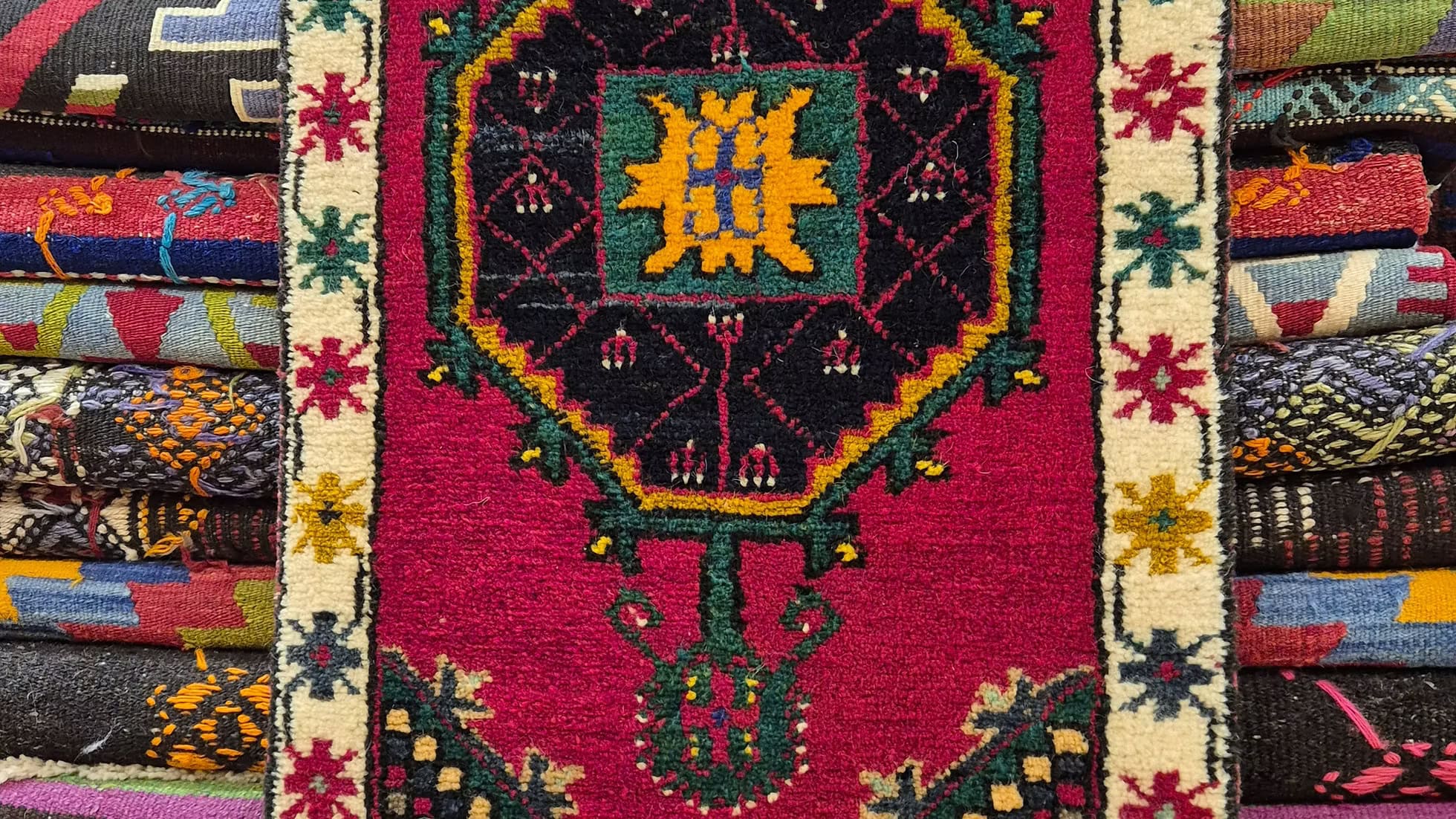 Close-up of hand-spun wool and dense knotting on Akşehir pillow-size floral rug with medallion design