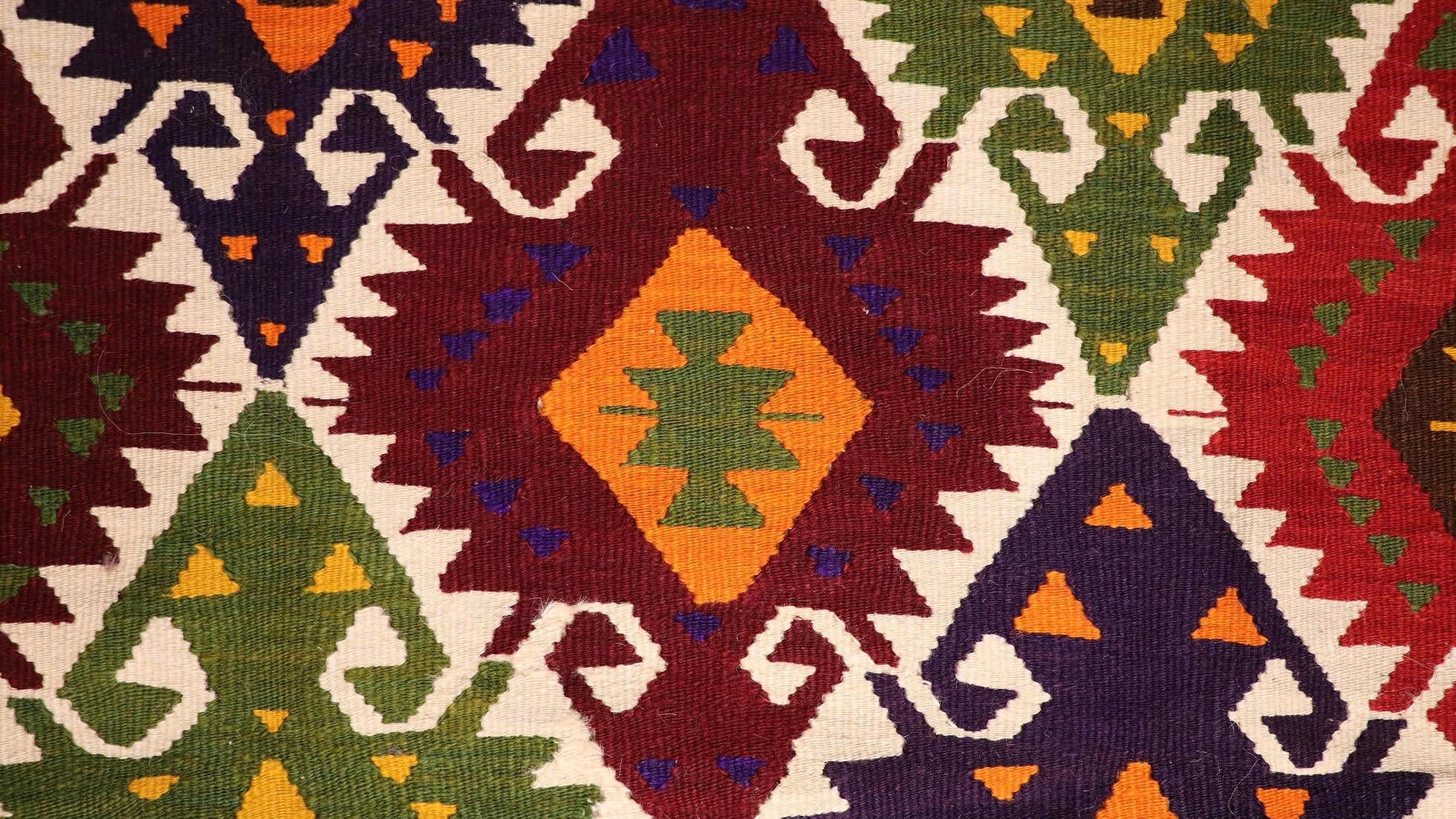 a luxury nomadic handwoven vintage Turkish kilim rug from Antalya in rustic earth tones and tribal motifs
