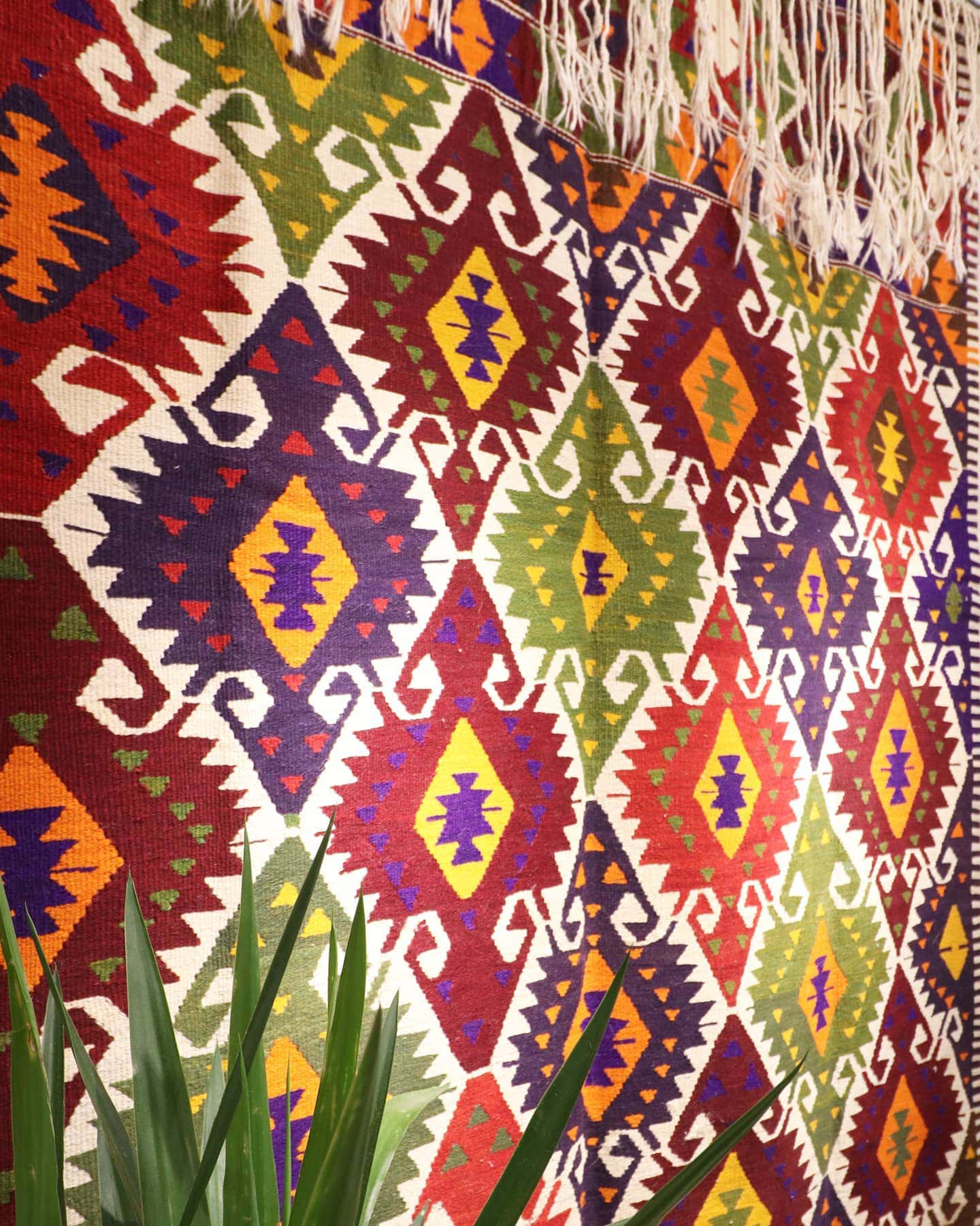 a luxury nomadic handwoven vintage Turkish kilim rug from Antalya in rustic earth tones and tribal motifs
