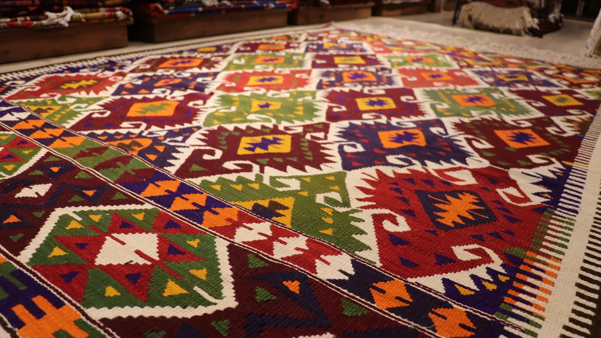 a luxury nomadic handwoven vintage Turkish kilim rug from Antalya in rustic earth tones and tribal motifs
