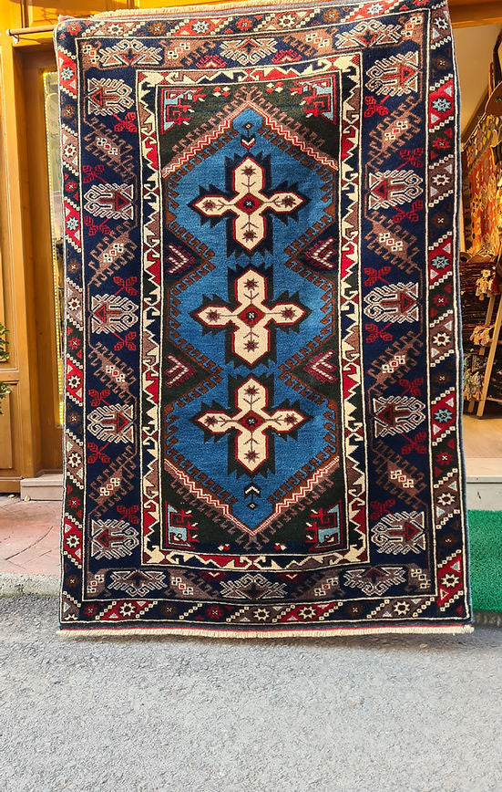 Vintage Turkish Dosemealti area rug from 1960s-1970s, 4x6 ft, handwoven in Antalya with Gordes knot. Features sky blue base, ivory accents, and deep sapphire and onyx tones, crafted from natural wool.
