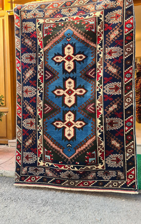 Vintage Turkish Dosemealti area rug from 1960s-1970s, 4x6 ft, handwoven in Antalya with Gordes knot. Features sky blue base, ivory accents, and deep sapphire and onyx tones, crafted from natural wool.