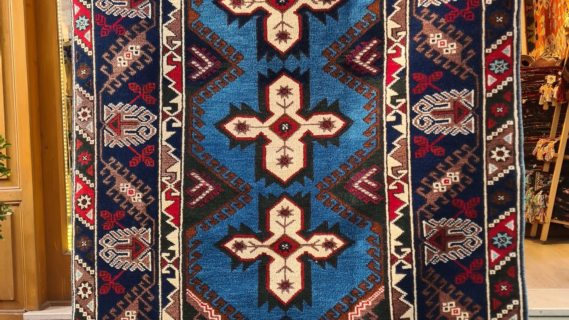 Vintage Turkish Dosemealti area rug from 1960s-1970s, 4x6 ft, handwoven in Antalya with Gordes knot. Features sky blue base, ivory accents, and deep sapphire and onyx tones, crafted from natural wool.