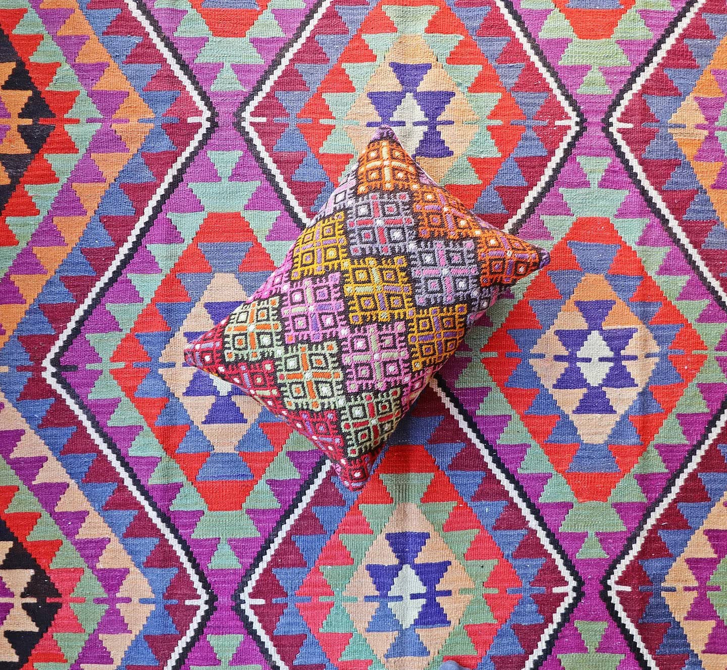 a close-up photo of the beautiful handwoven Turkish kilim rug in traditional and tribal motifs made by nomadic women weavers