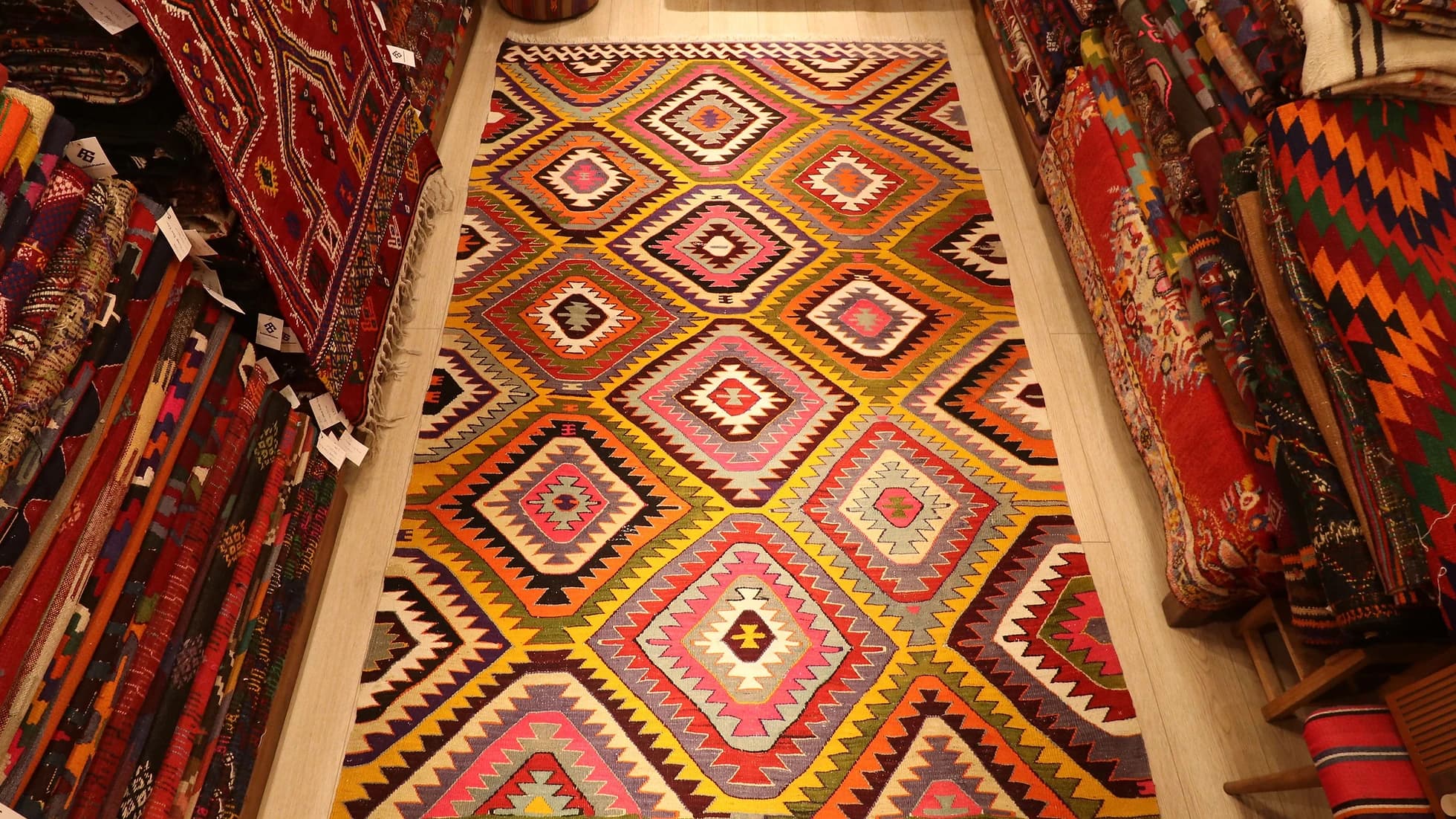 a magnificent mid-century Turkish tribal rug in bright and bold colors and geometric diamond patterns from Antalya