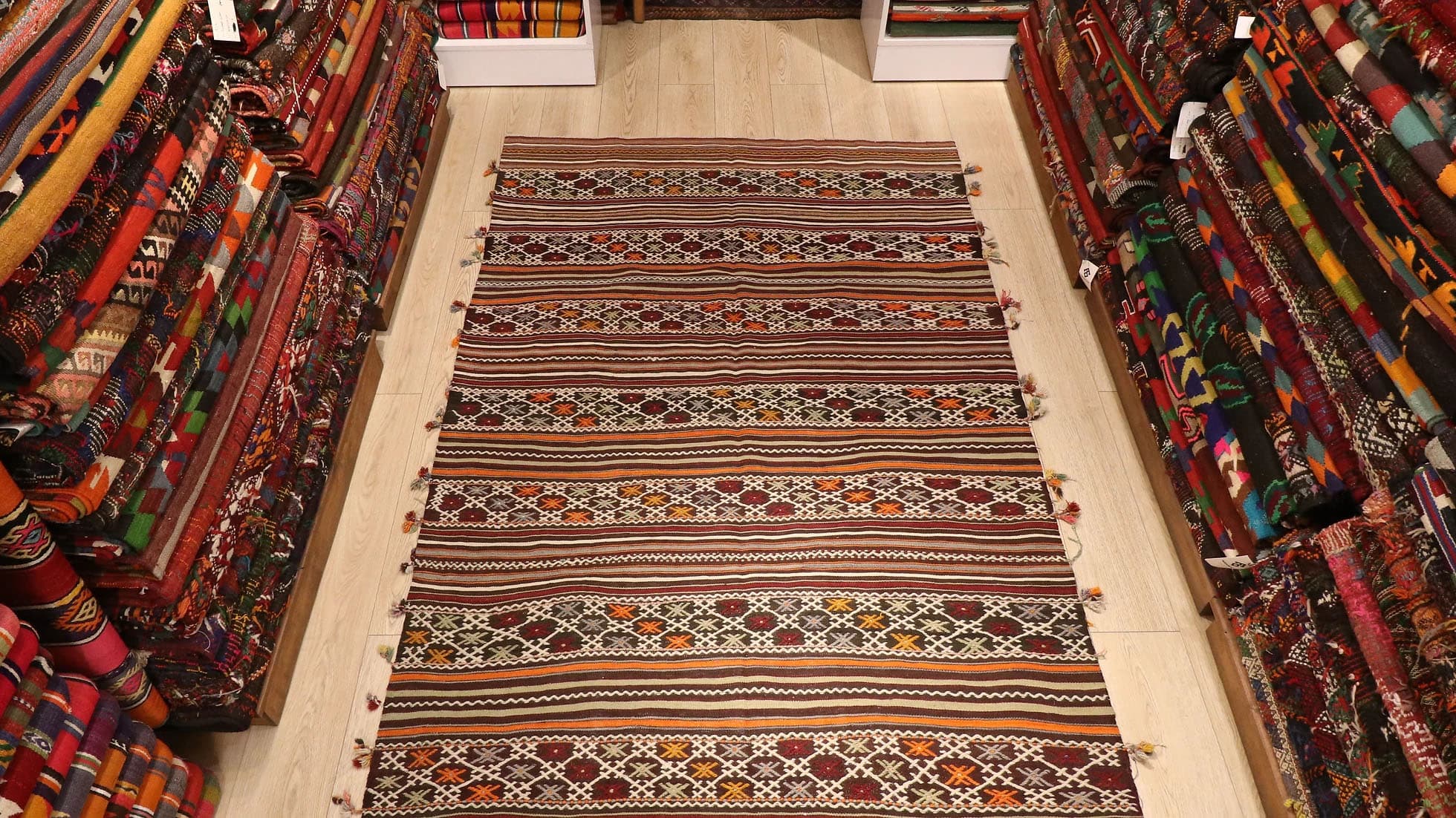 a very rare semi-antique Turkish rug with intricate tassels in rustic, neutral, earthy, and pastel color palette