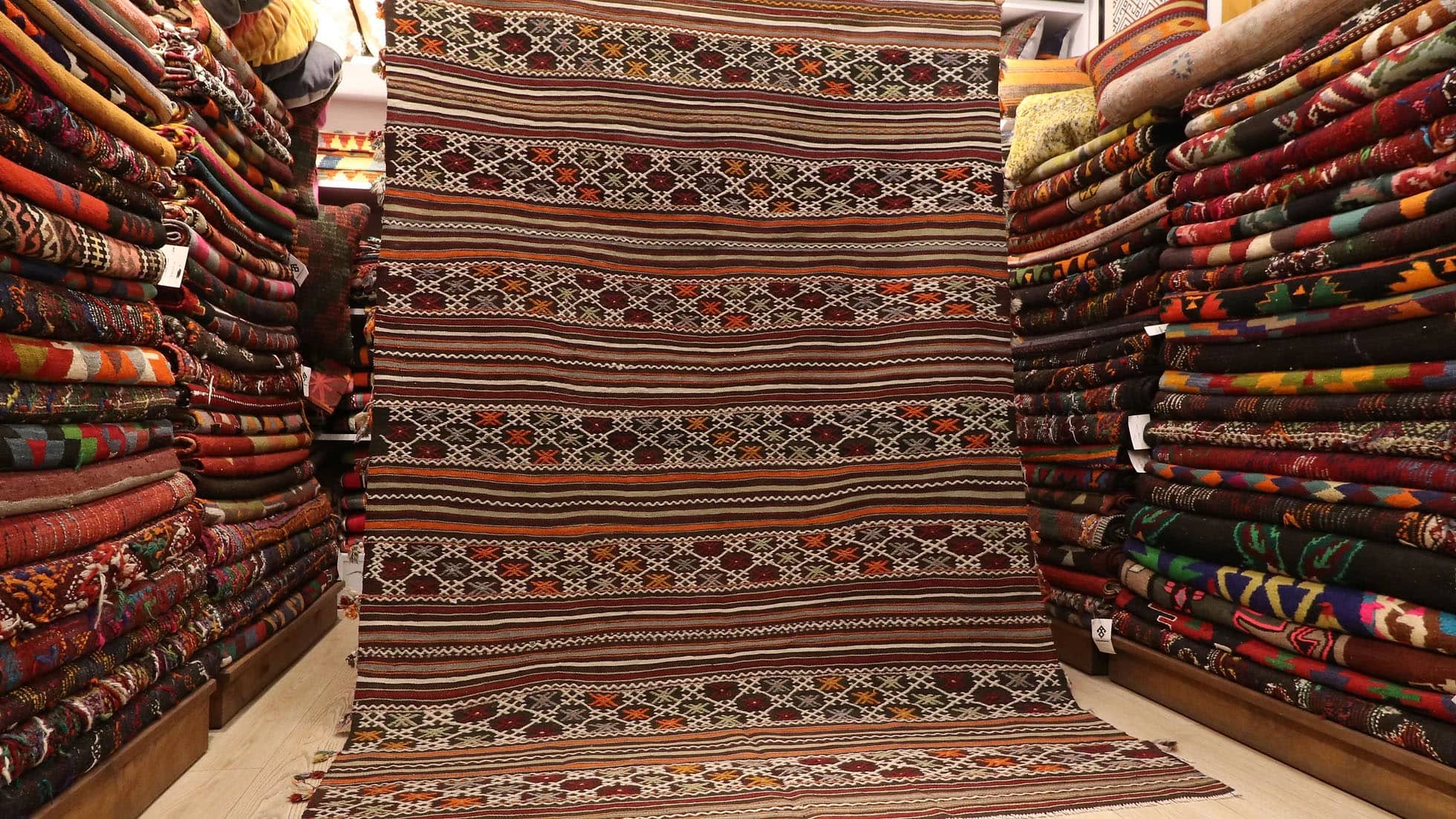 a very rare semi-antique Turkish rug with intricate tassels in rustic, neutral, earthy, and pastel color palette
