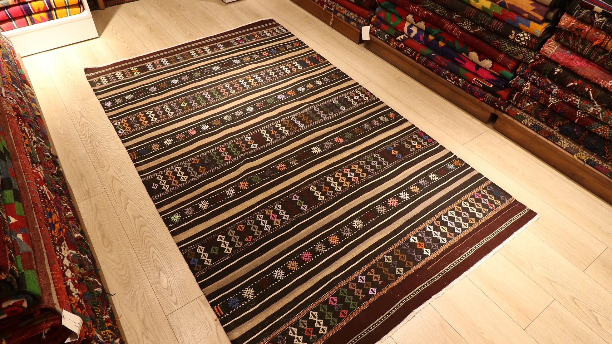 mid-century Turkish tribal flat-woven rug featuring pastel traditional Anatolian kilim motifs and stripes in brown and gold from Balikesir