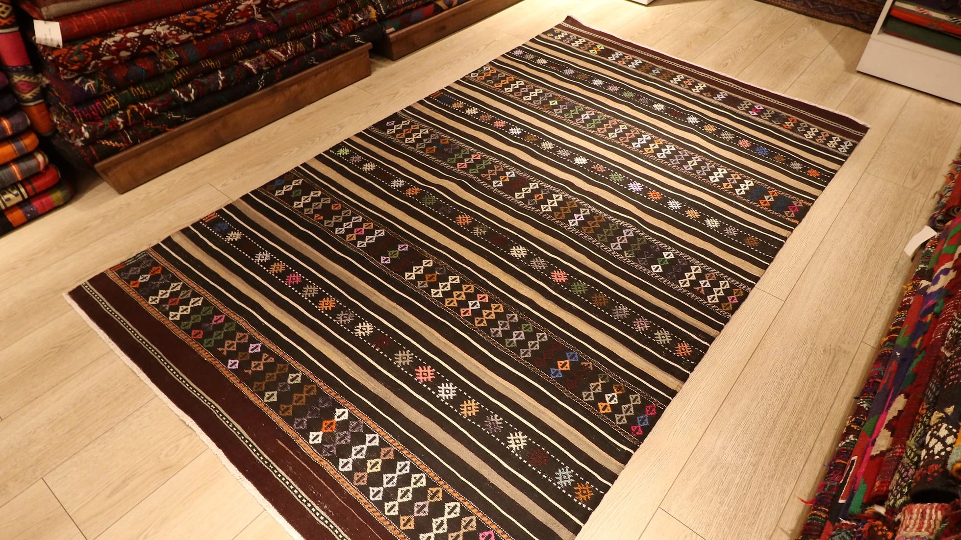 mid-century Turkish tribal flat-woven rug featuring pastel traditional Anatolian kilim motifs and stripes in brown and gold from Balikesir