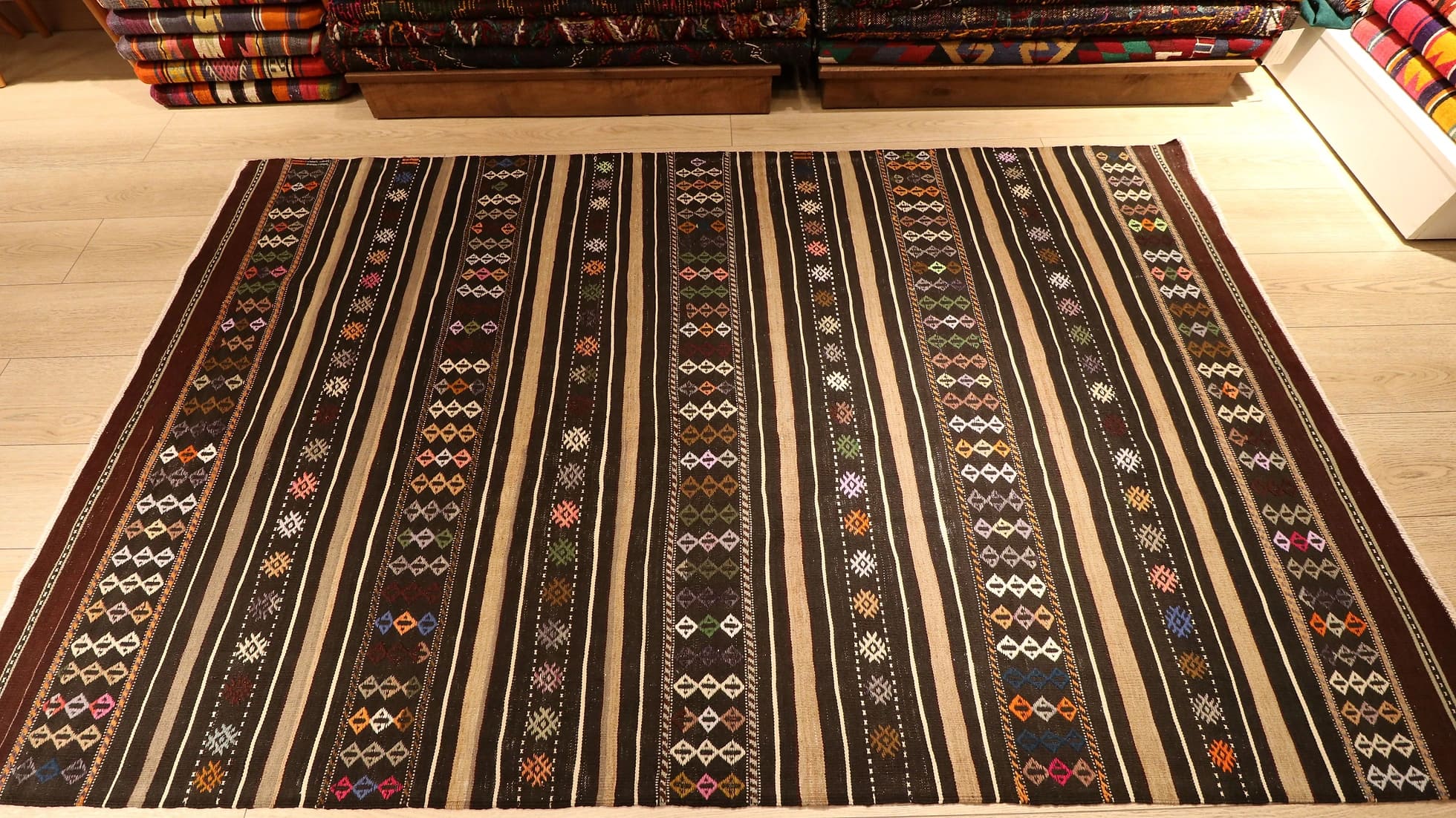mid-century Turkish tribal flat-woven rug featuring pastel traditional Anatolian kilim motifs and stripes in brown and gold from Balikesir
