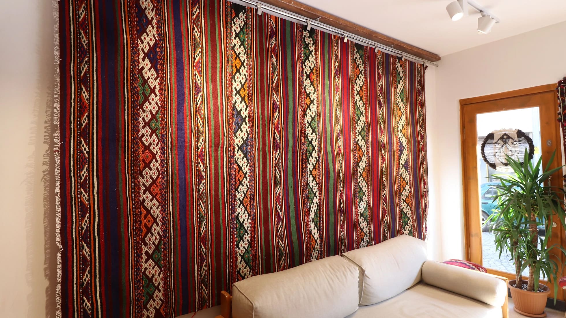 magnificent Turkish Balikesir kilim rug hand-knotted in the mid-century featuring colorful stripes and tribal style hanging on the wall as a tapestry