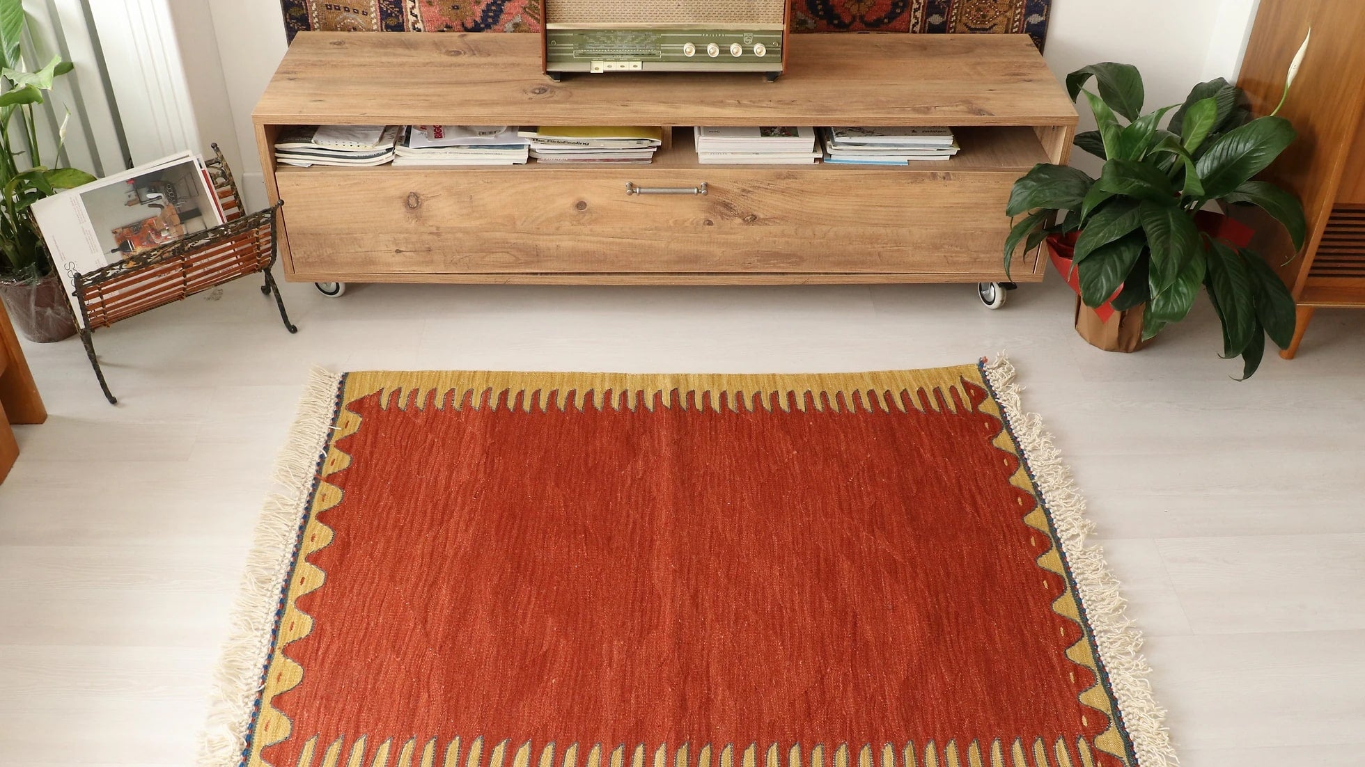 simple and minimal Turkish rug in red and yellow showcasing traditional motifs and white tassels/fringes sourced from the world-renowned city Bodrum