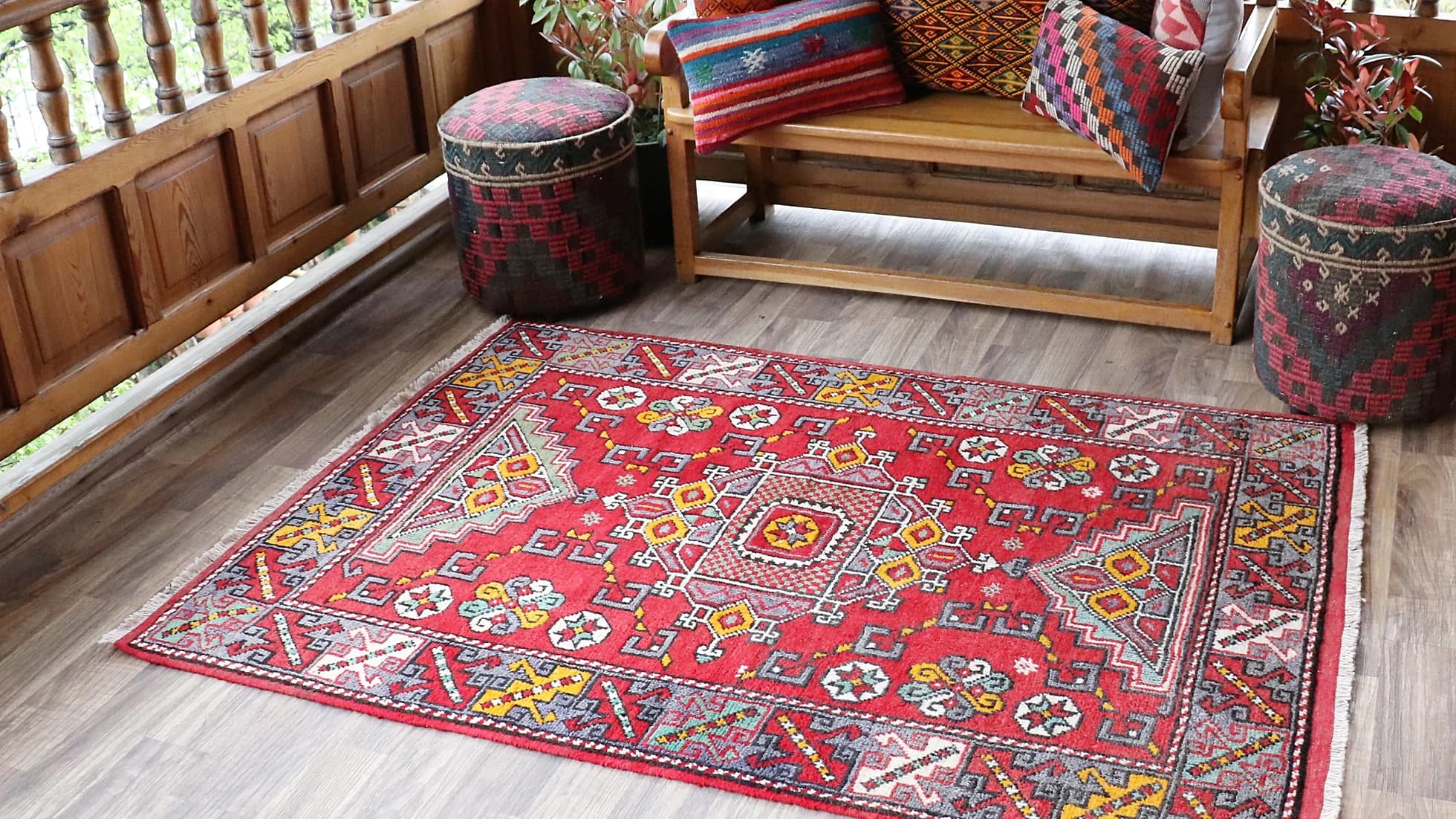 vintage and luxury transitional Turkish handwoven rug from Canakkale in fiery red, burnt yellow, and ocean turquoise on a traditional patio