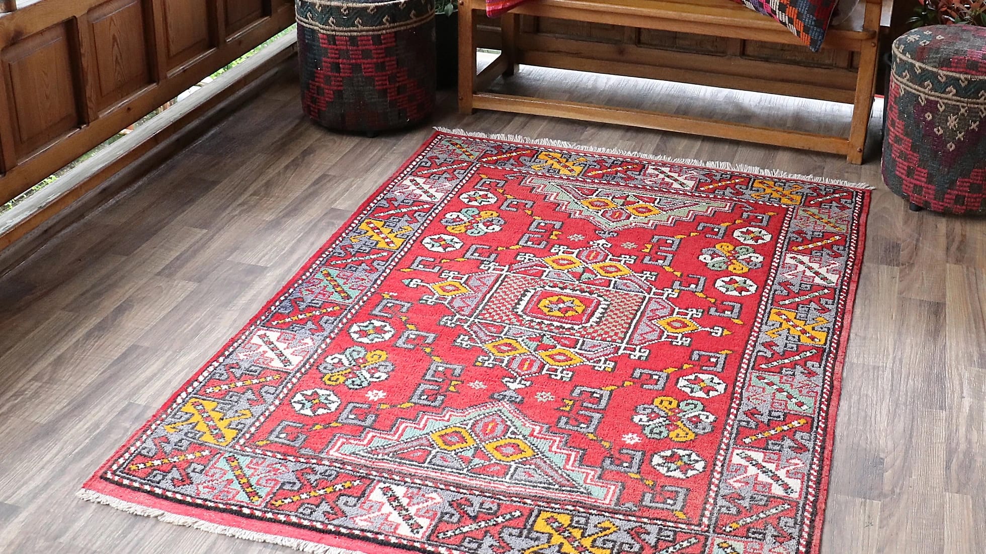 vintage and luxury transitional Turkish handwoven rug from Canakkale in fiery red, burnt yellow, and ocean turquoise on a traditional patio
