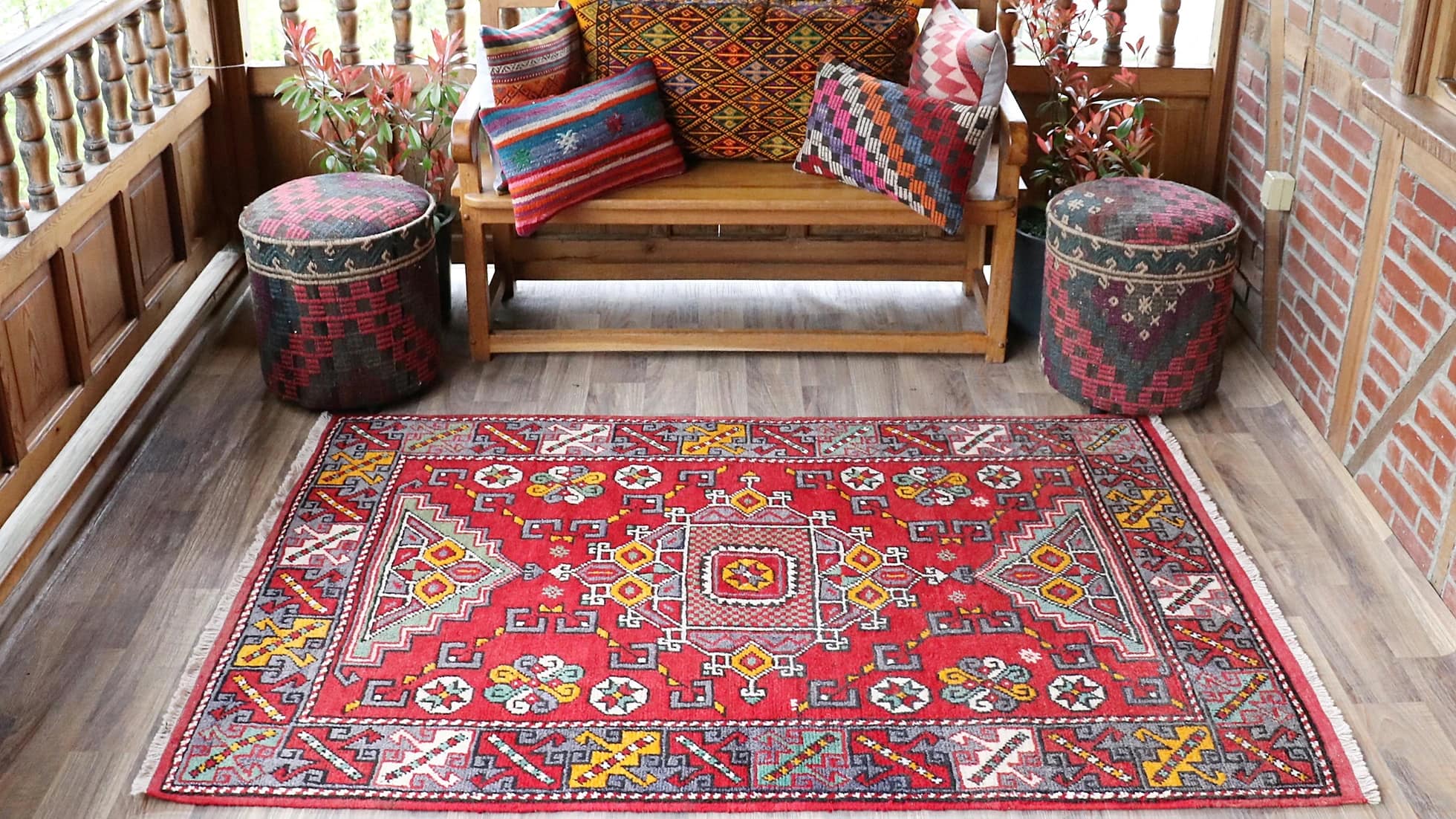 vintage and luxury transitional Turkish handwoven rug from Canakkale in fiery red, burnt yellow, and ocean turquoise on a traditional patio