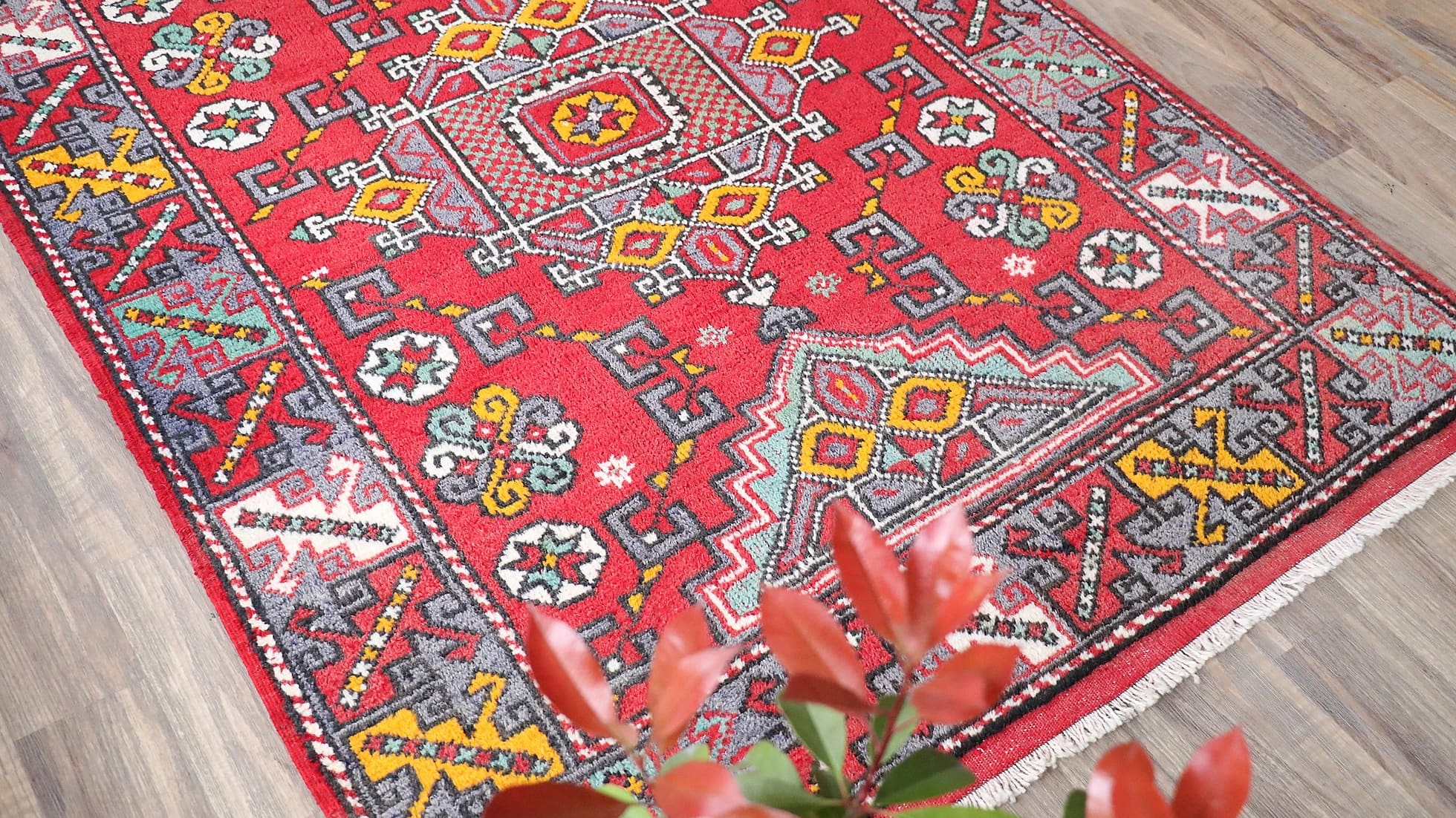 vintage and luxury transitional Turkish handwoven rug from Canakkale in fiery red, burnt yellow, and ocean turquoise on a traditional patio