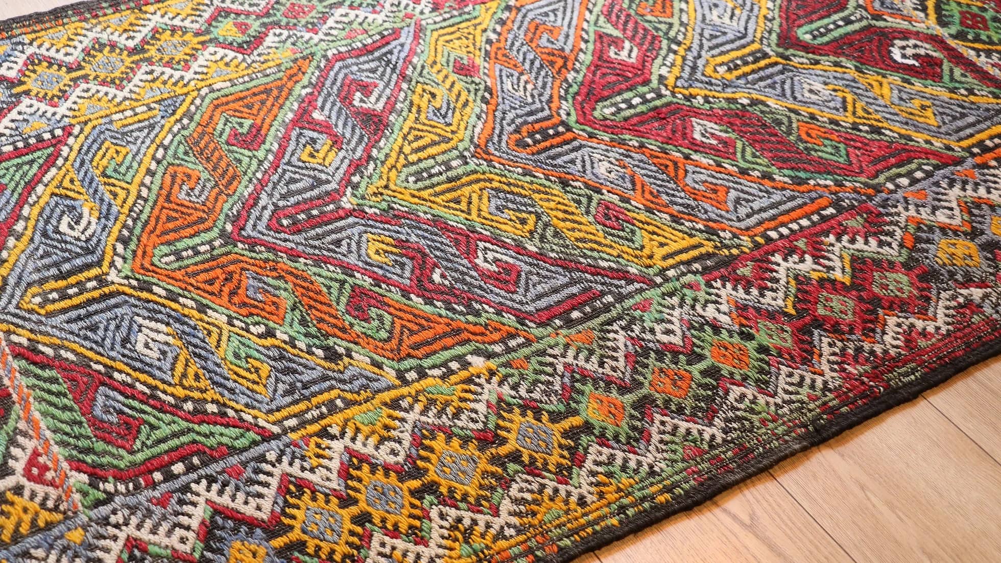 vintage mid-century Turkish rug from 1950s featuring traditional kilim motifs in many vivid and vibrant colors