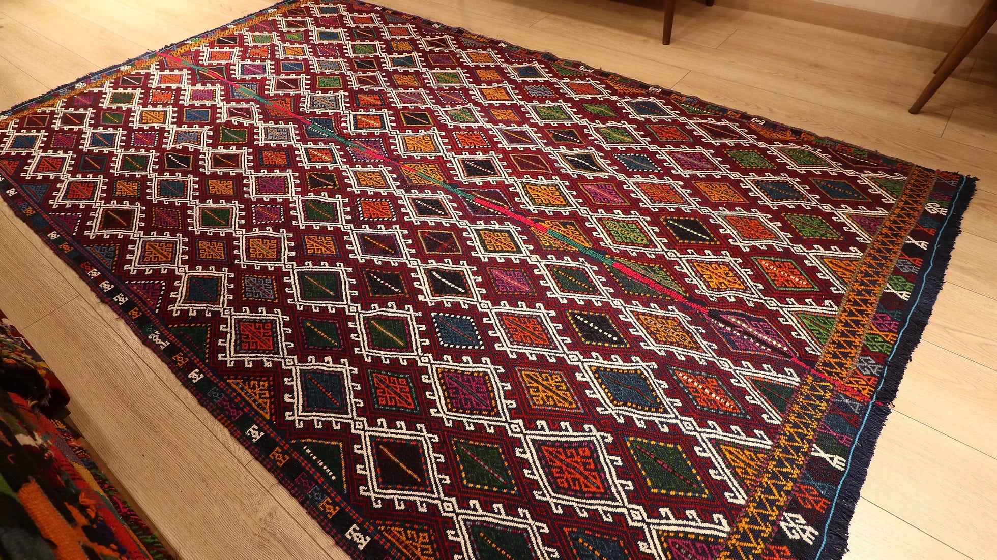 a perfect mid-century tribal Kurdish rug from Denizli, Turkey featuring traditional kilim motifs in muted and faded earth tones