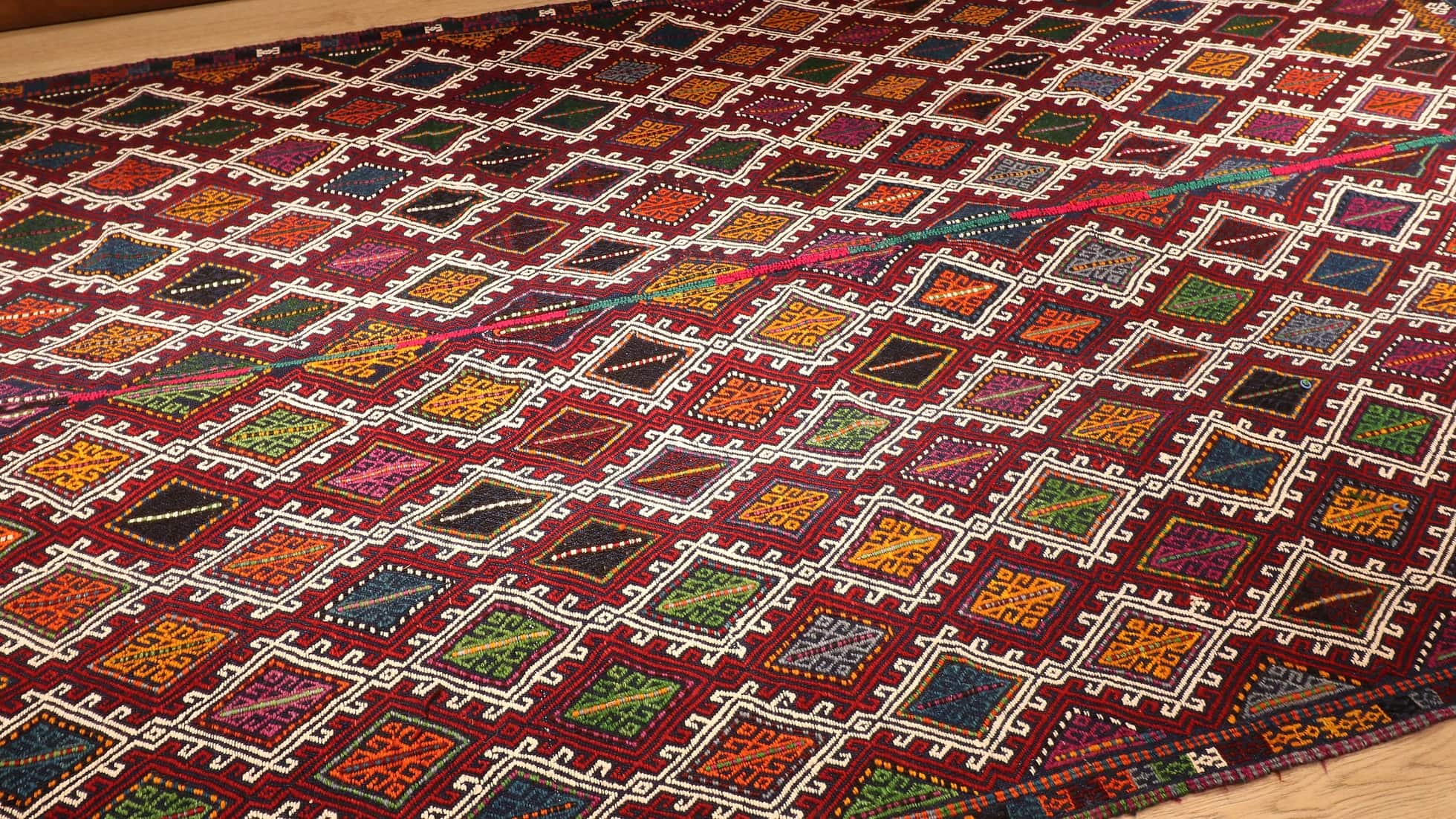 a perfect mid-century tribal Kurdish rug from Denizli, Turkey featuring traditional kilim motifs in muted and faded earth tones