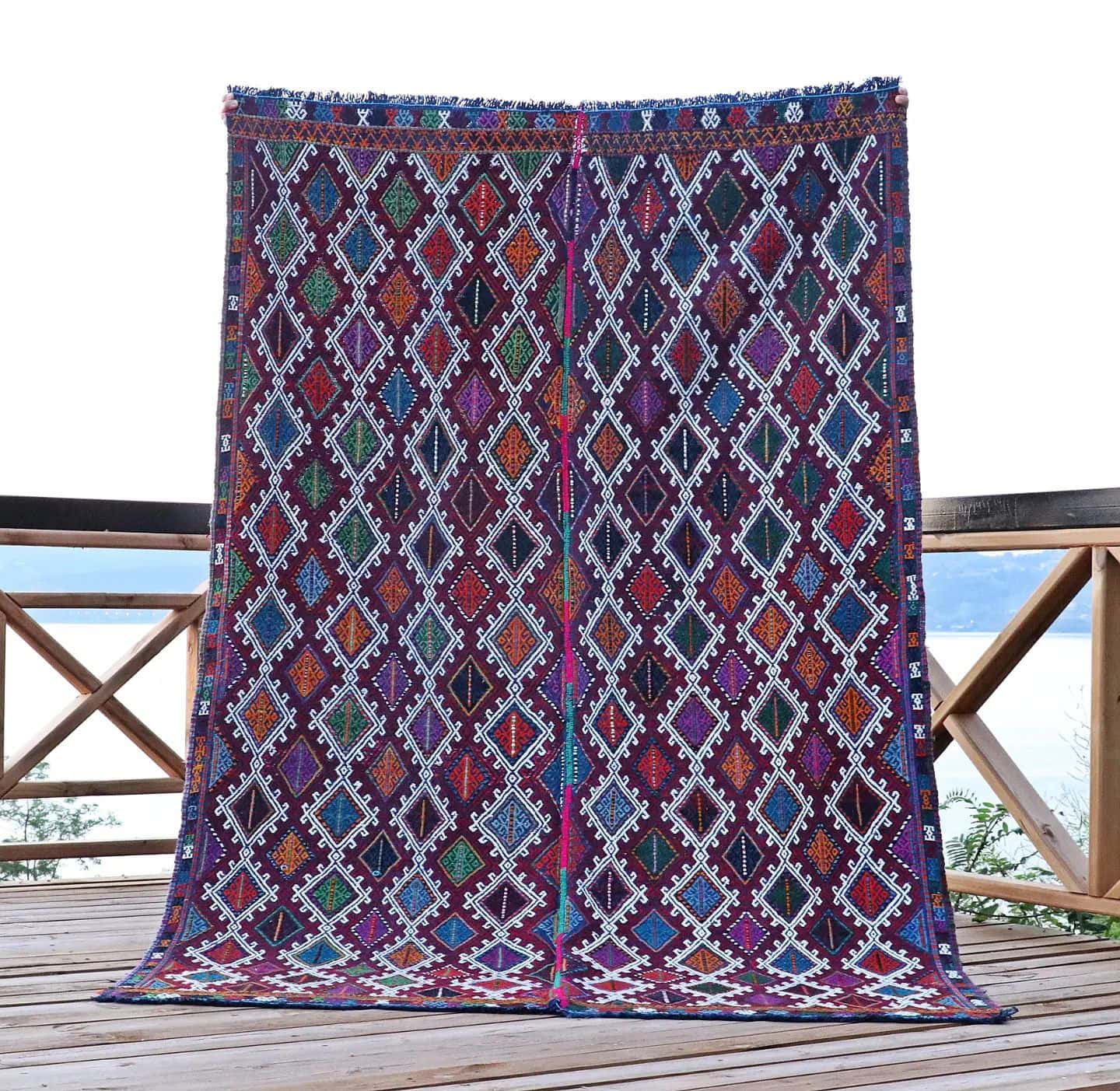 a perfect mid-century tribal Kurdish rug from Denizli, Turkey featuring traditional kilim motifs in muted and faded earth tones