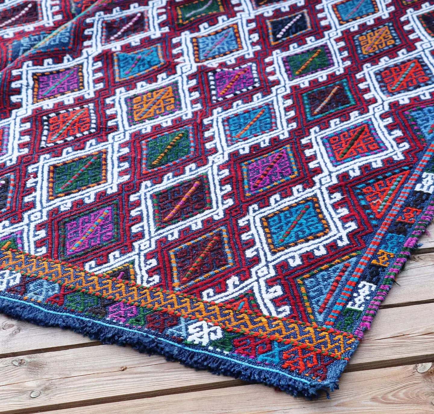 a perfect mid-century tribal Kurdish rug from Denizli, Turkey featuring traditional kilim motifs in muted and faded earth tones