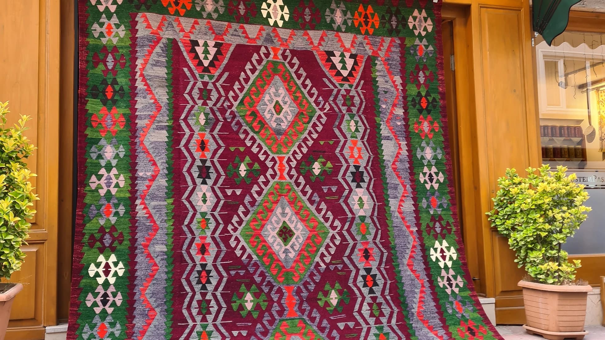 Vintage Handmade Turkish Rug with geometric patterns in red, grey, green in tribal style