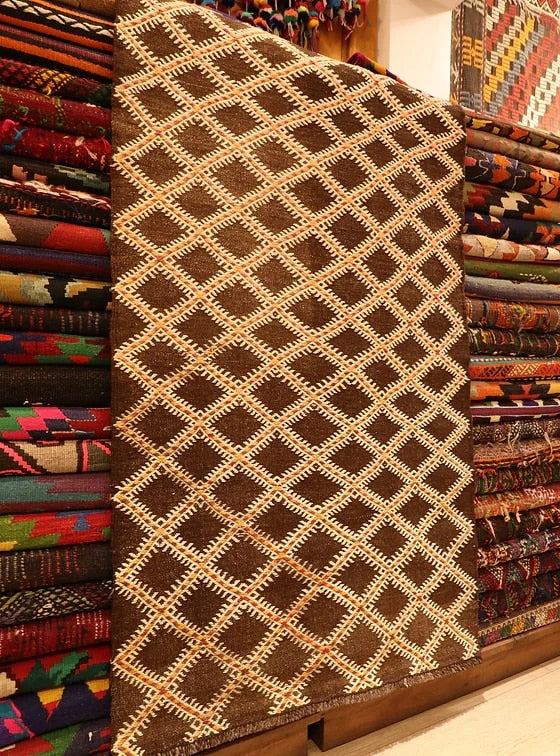 rare hand-knotted flat-woven rug in earthy rustic colors and diamond patterns from 1940s