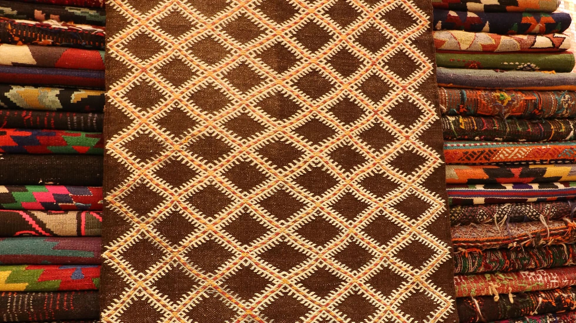 rare hand-knotted flat-woven rug in earthy rustic colors and diamond patterns from 1940s