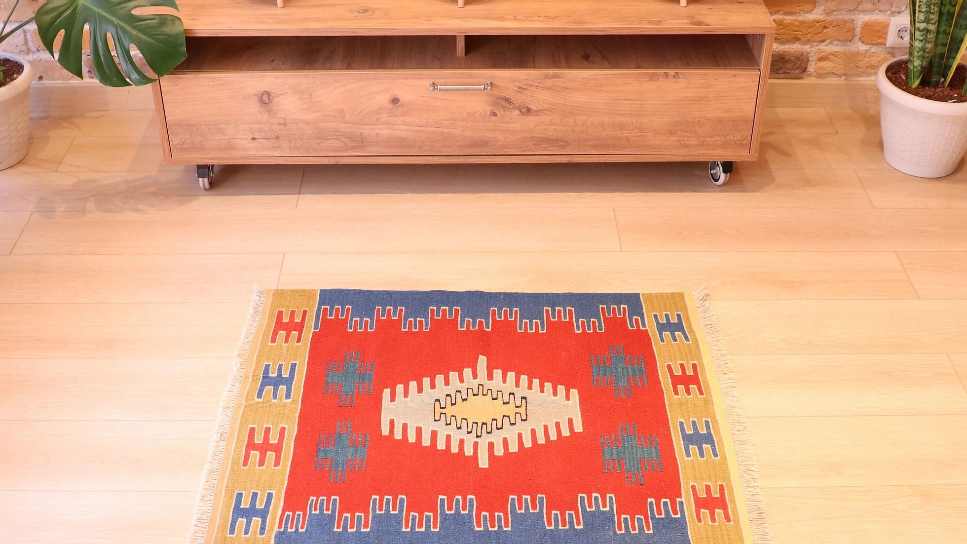 a small and captivating Ushak kilim rug in red, blue, and gold by Kilim Couture New York