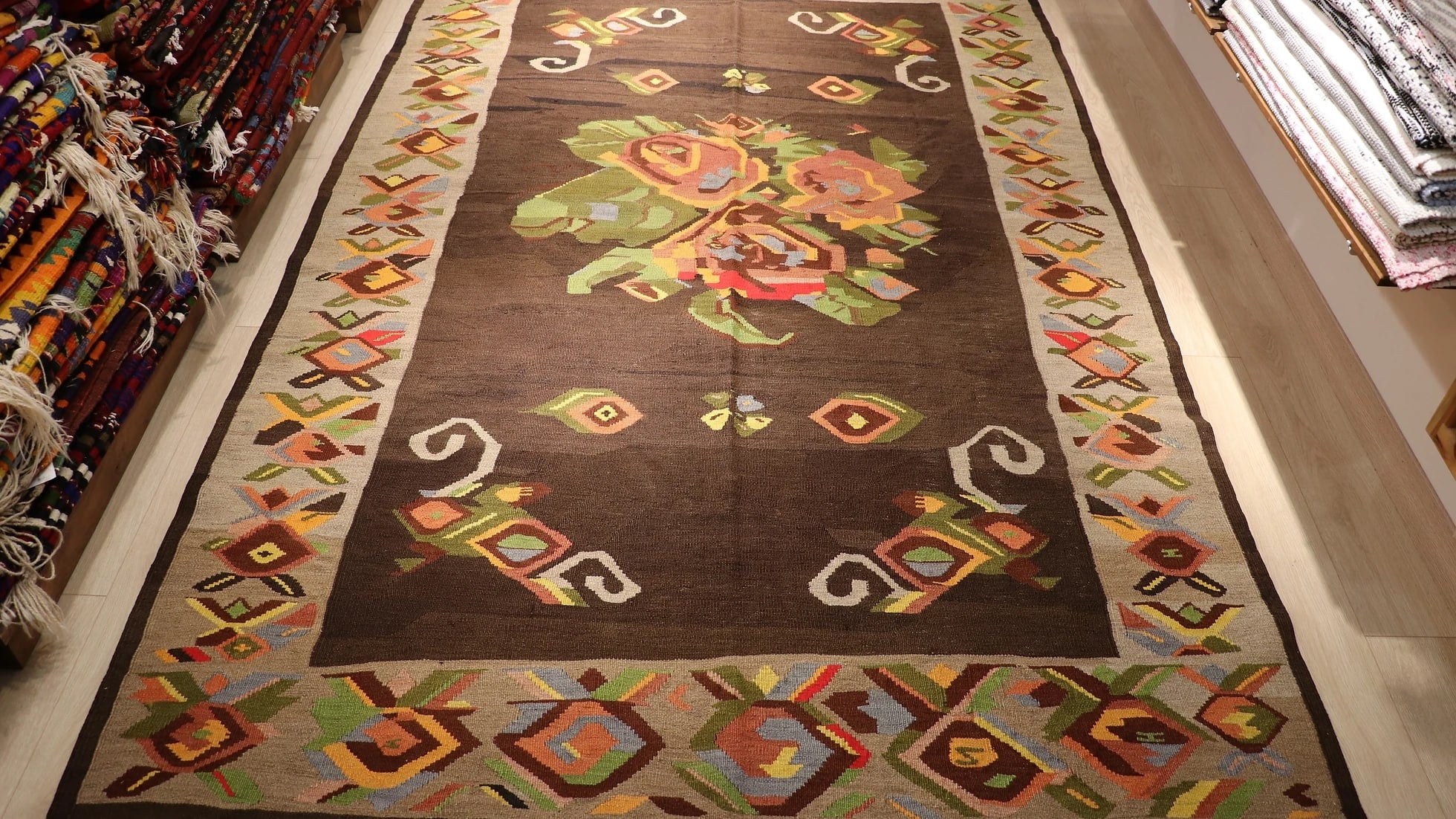 floral antique Turkish tapestry rug from Kars in muted and faded colors featuring giant colorful flower motifs