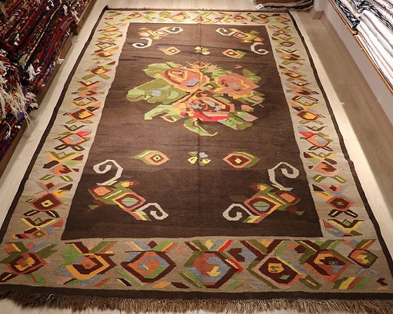 floral antique Turkish tapestry rug from Kars in muted and faded colors featuring giant colorful flower motifs