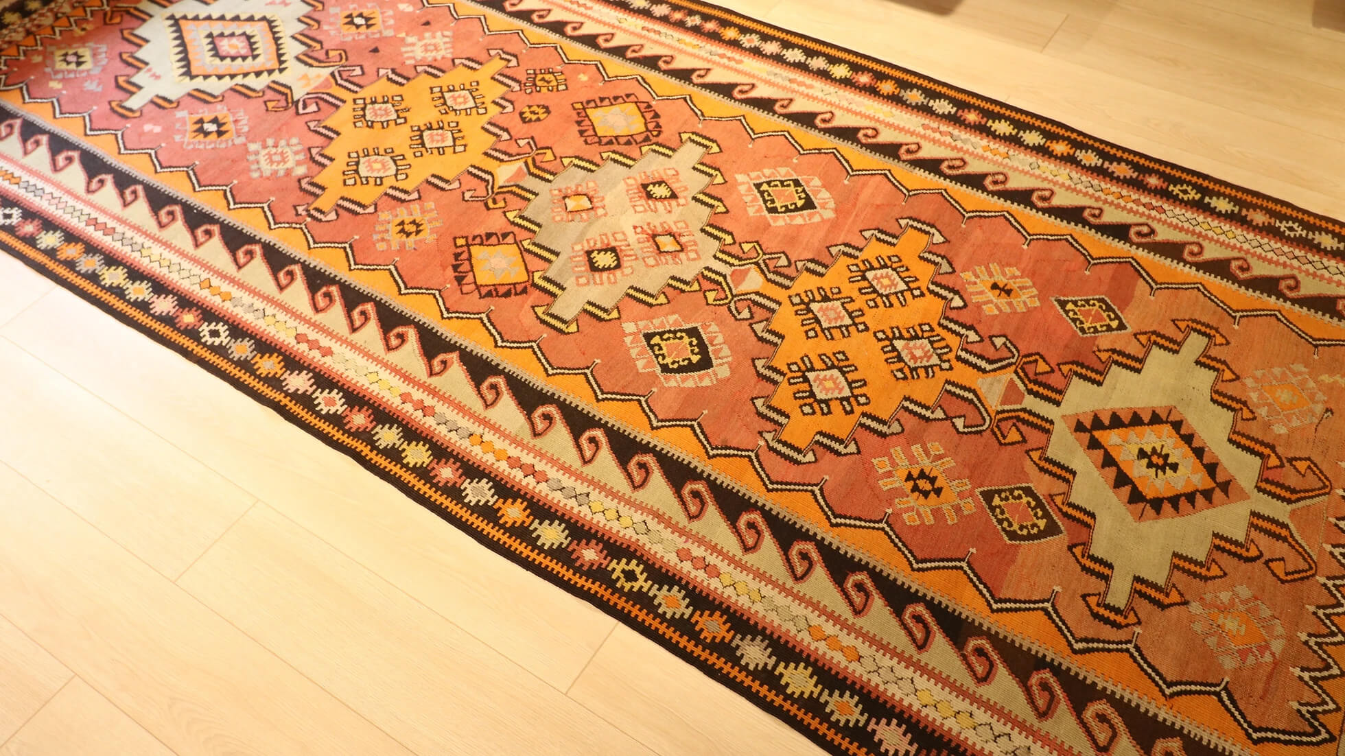 oriental Turkish runner in natural red, orange and ivory tones for rustic, farmhouse, and Southwestern interiors
