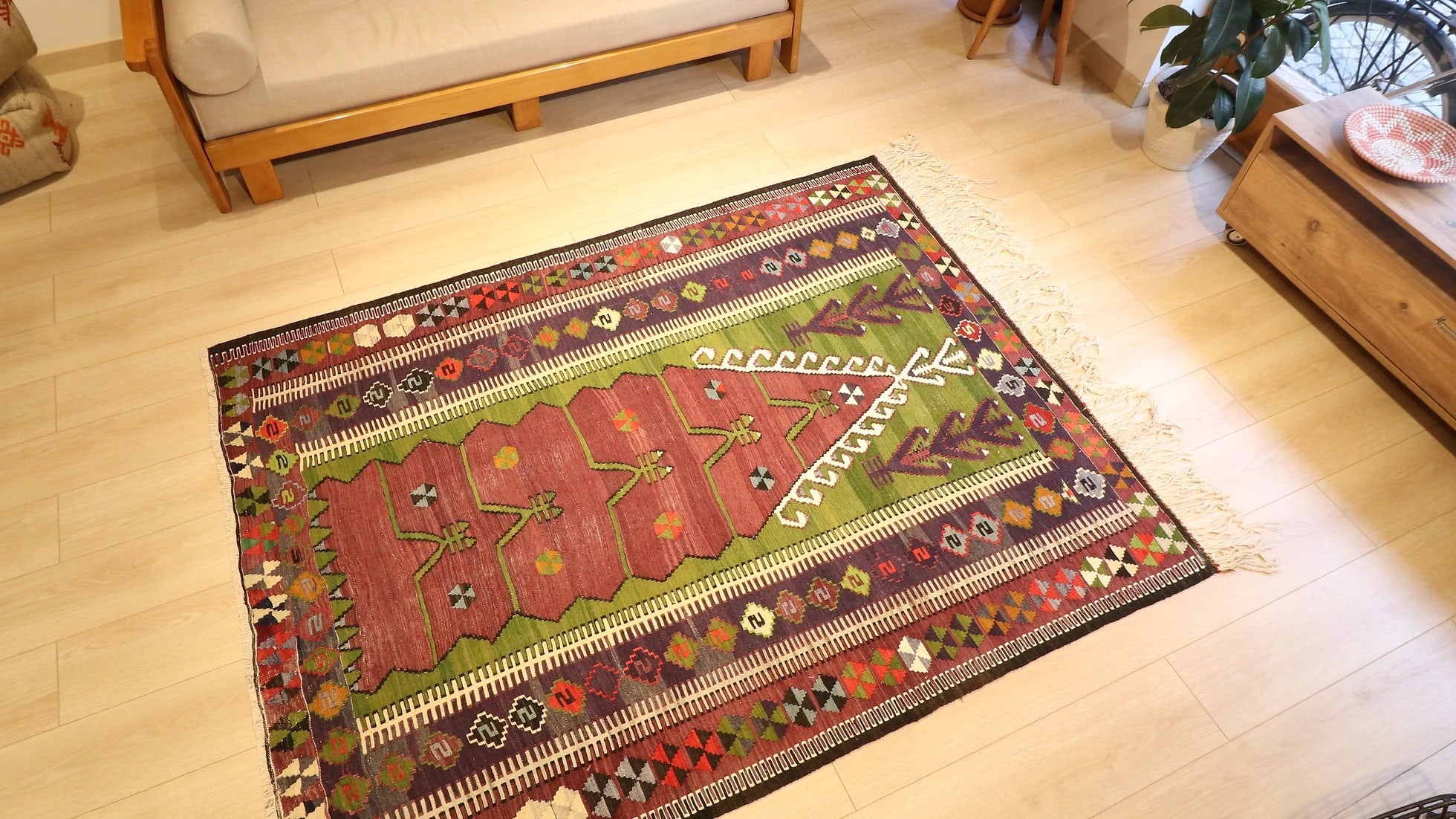 medium-sized handwoven Konya prayer rug with long white fringes featuring many traditional motifs and rustic colors