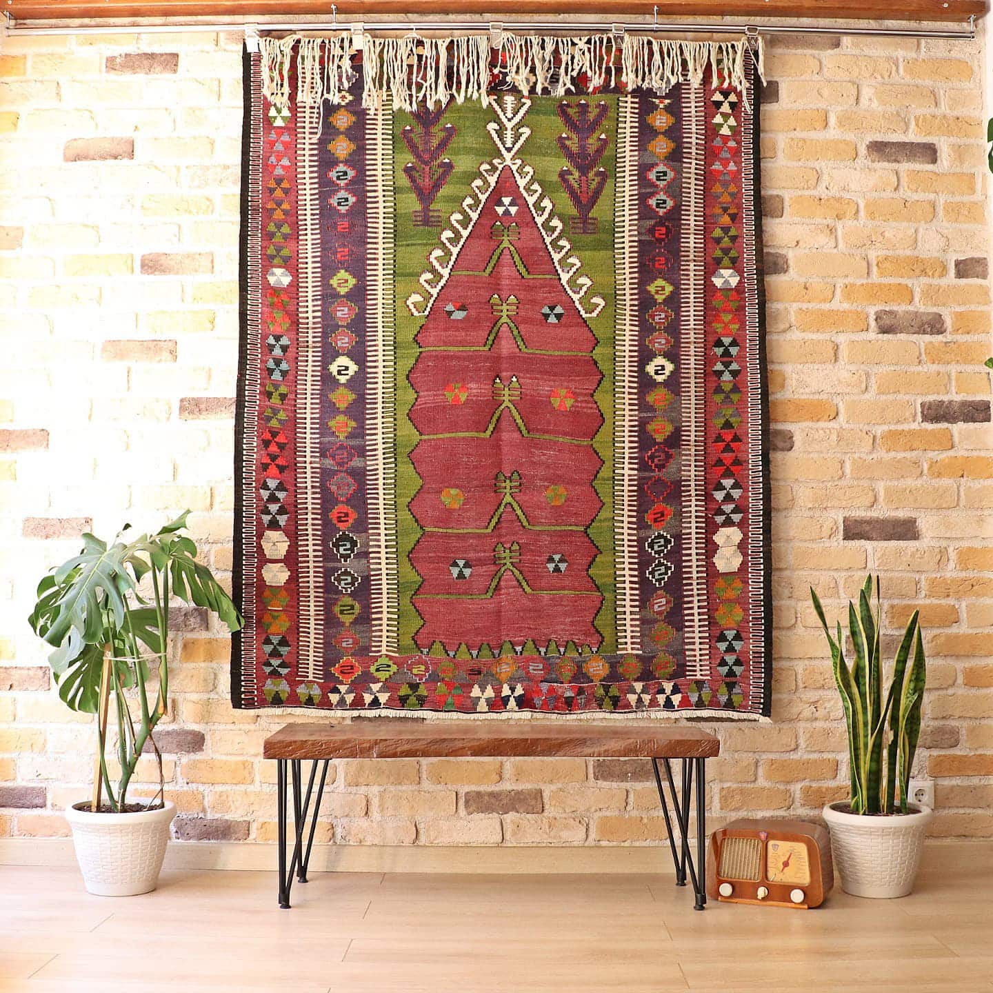 medium-sized handwoven Konya prayer rug with long white fringes featuring many traditional motifs and rustic colors