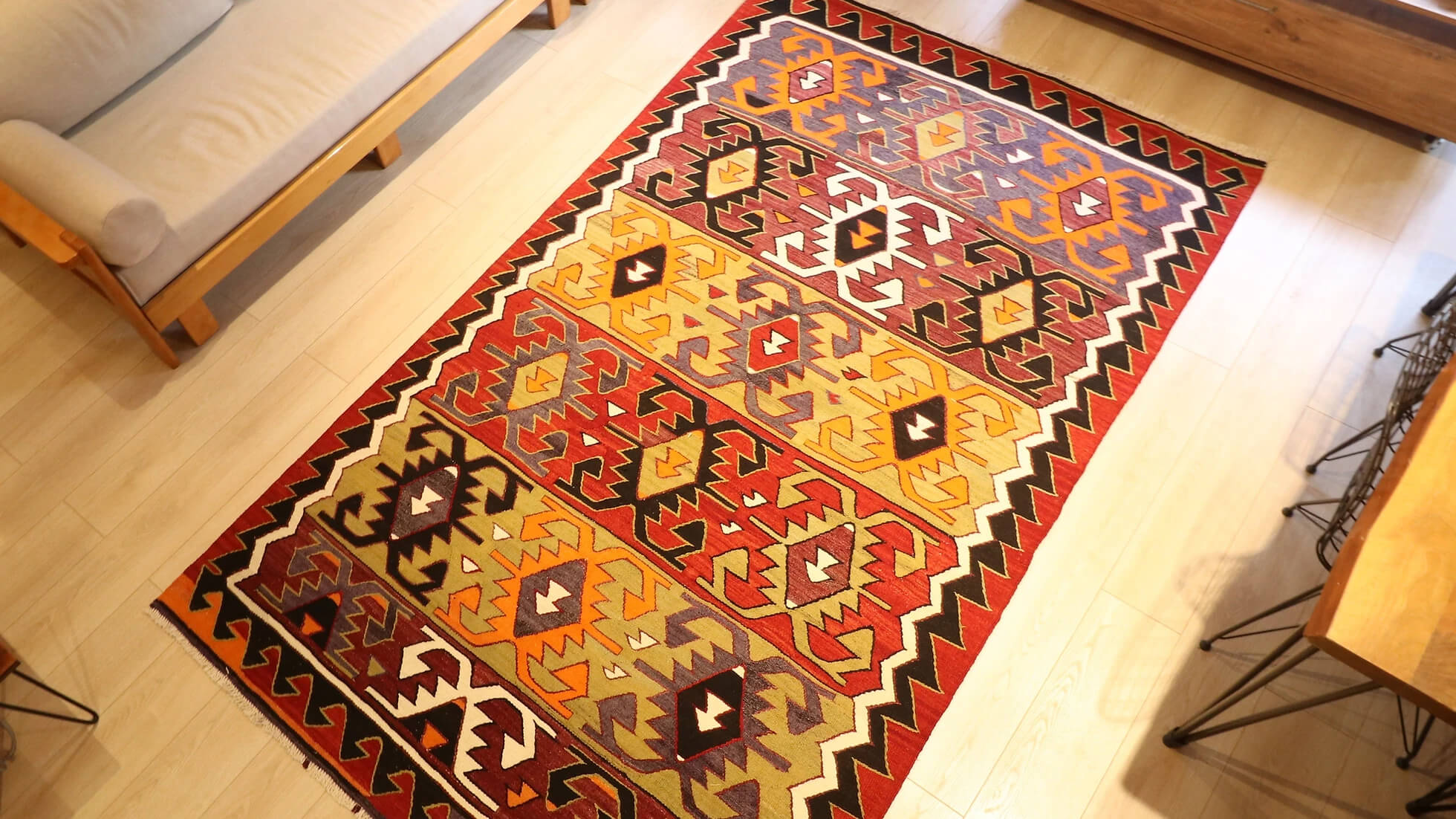 traditional hand-knotted Turkish rug from mid-century in red, black, green, and purple with geometric patterns