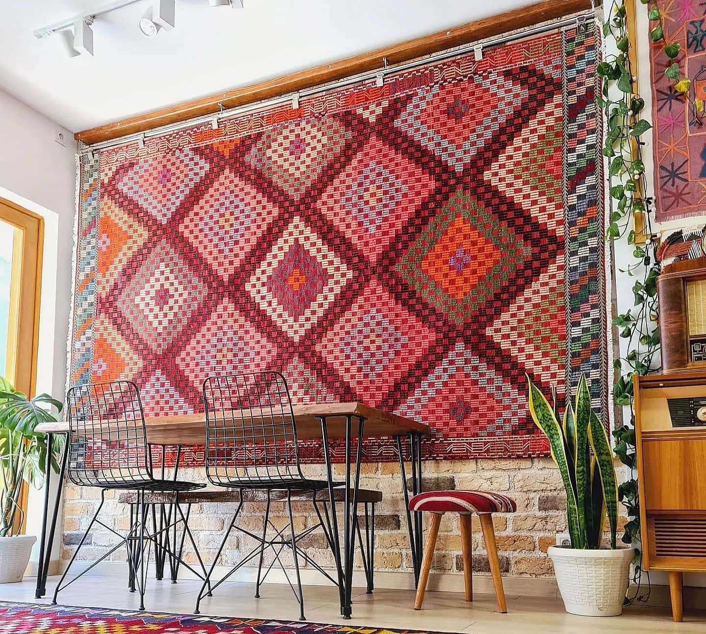 vintage handwoven Turkish wool rug in pastel pink, green, orange, blue, and purple tribal diamond patterns