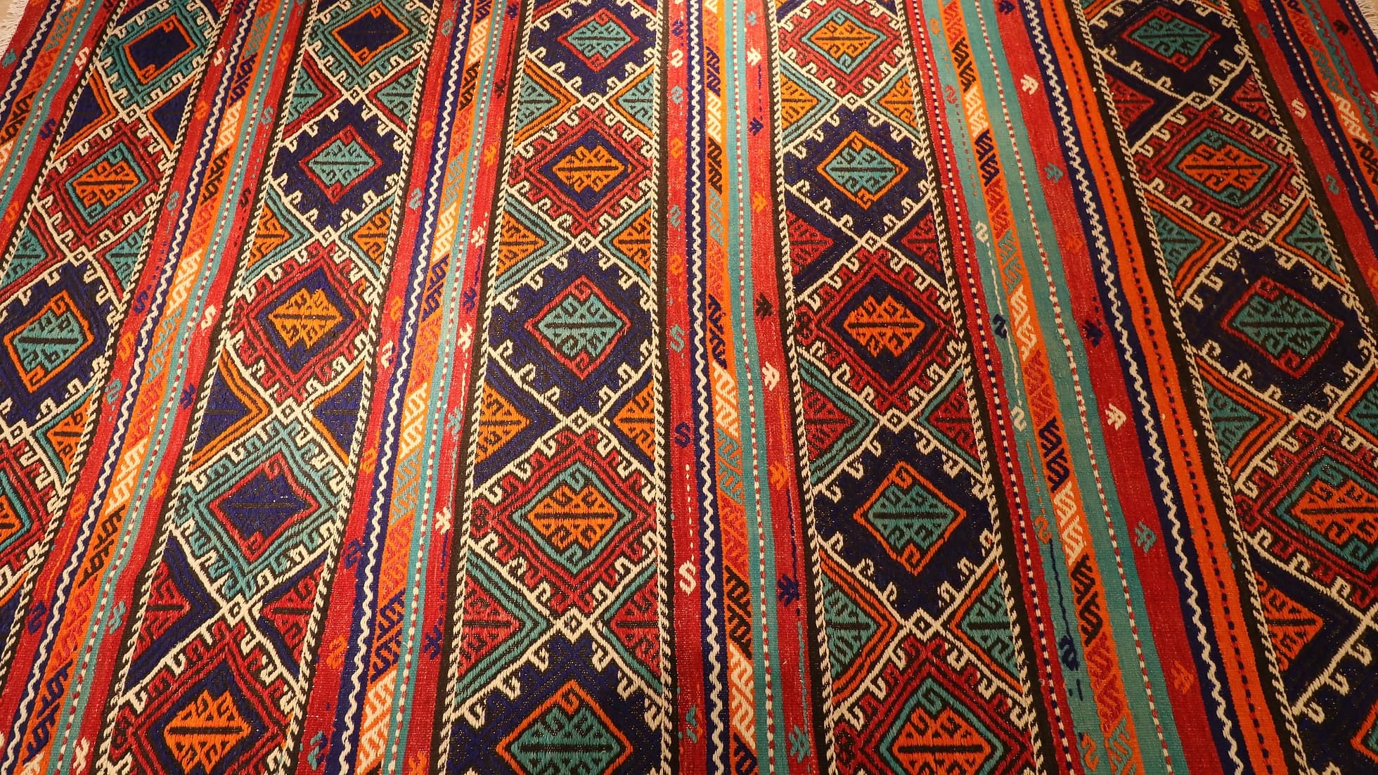 multicolored vintage Turkish tribal rug featuring traditional kilim motifs and modern colors from 1960s era
