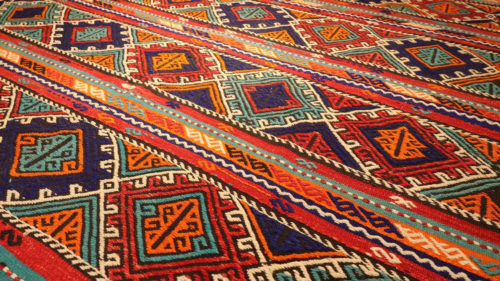 multicolored vintage Turkish tribal rug featuring traditional kilim motifs and modern colors from 1960s era