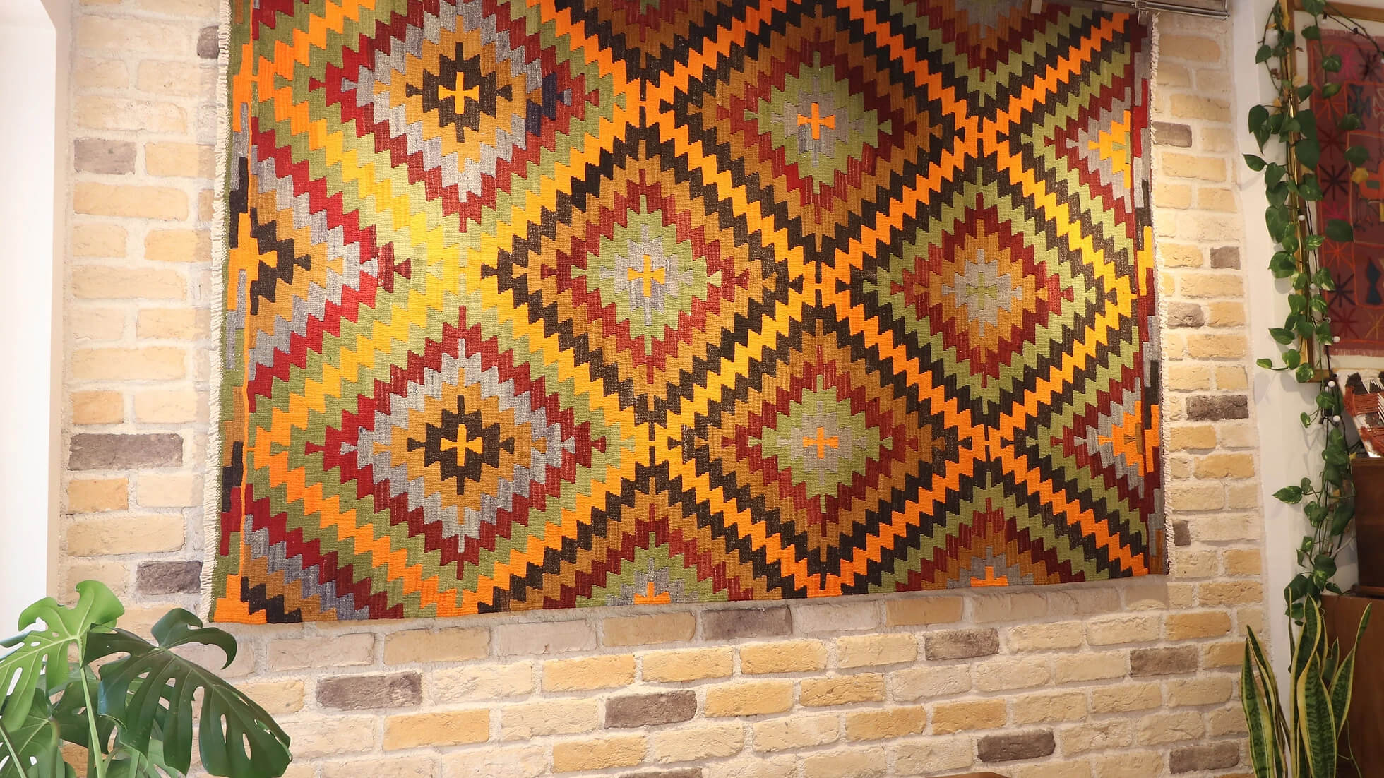 a 5x8 polychromatic luxury modern handwoven Turkish flat-woven rug in diamond and lozenge patterns