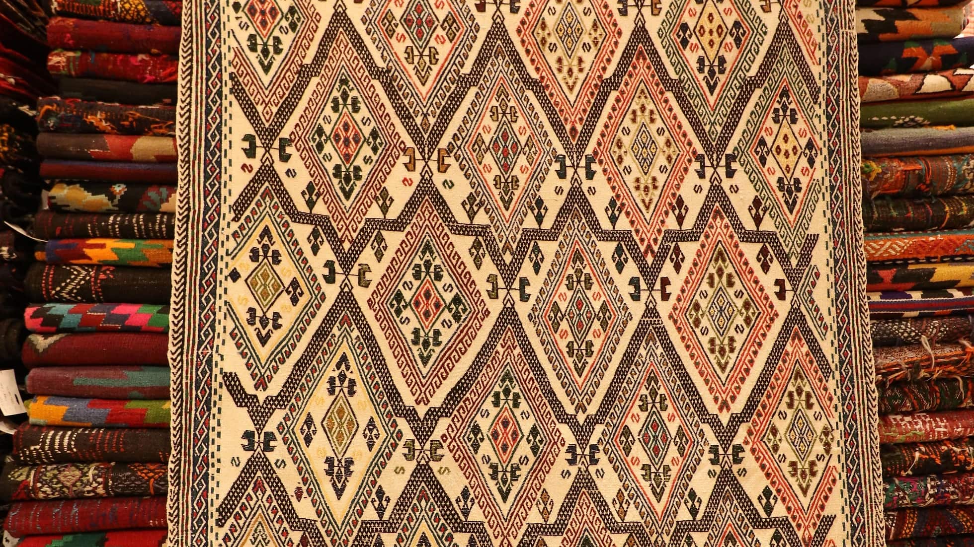 diamond patterned oriental Turkish hand-knotted wool rug in cream tones