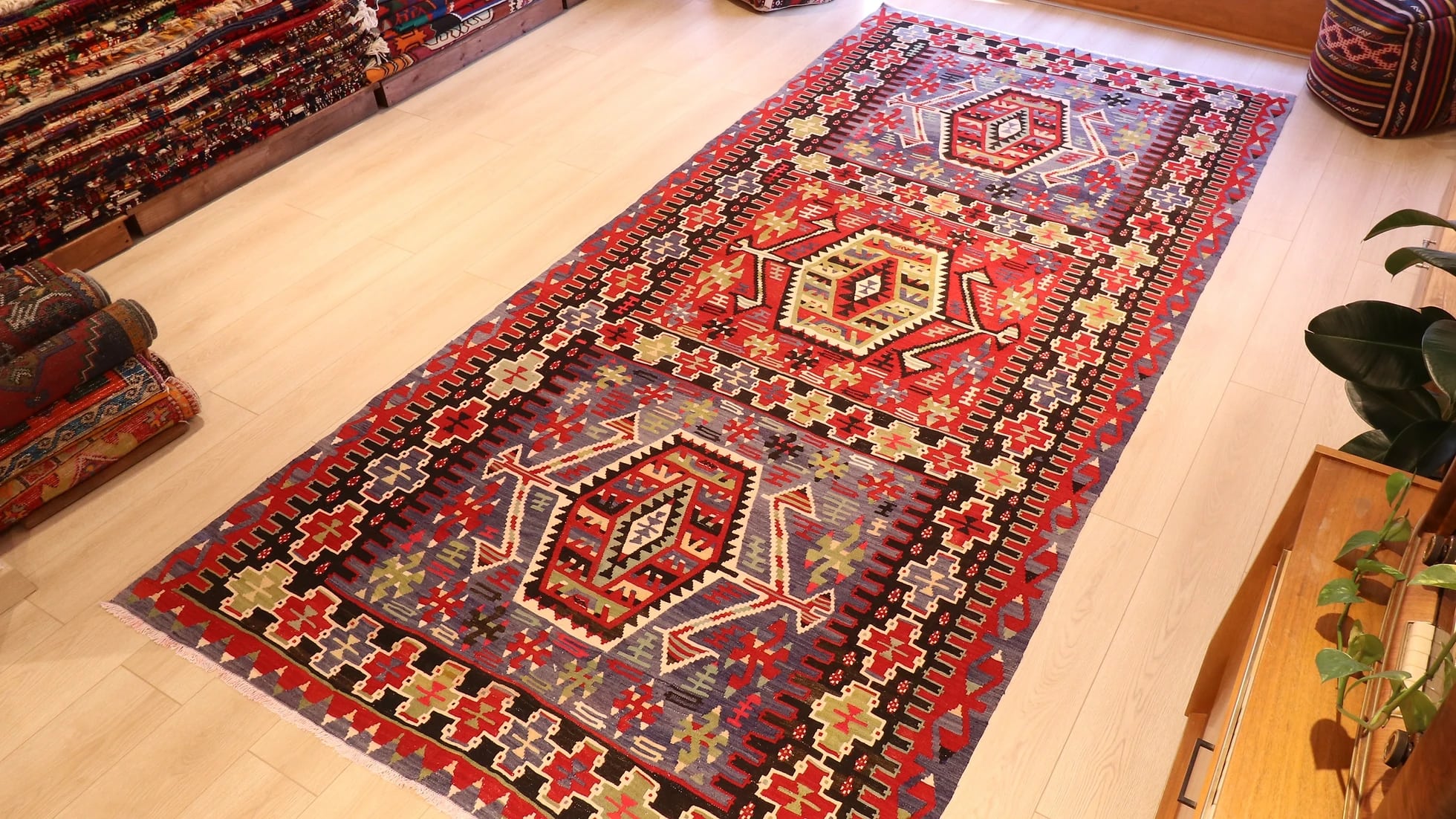 a rustic nomadic Turkish Esme Oushak Rug in many traditional motifs and earthy tones from the mid-century in a NYC rug gallery