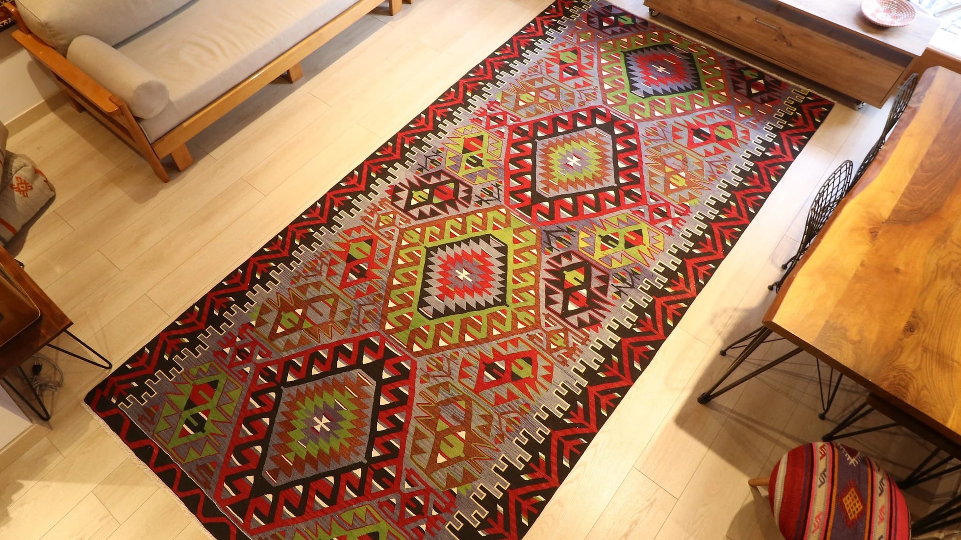 oversized vintage Oushak runner rug adorned with tribal motifs in rustic earth tones by Kilim Couture New York