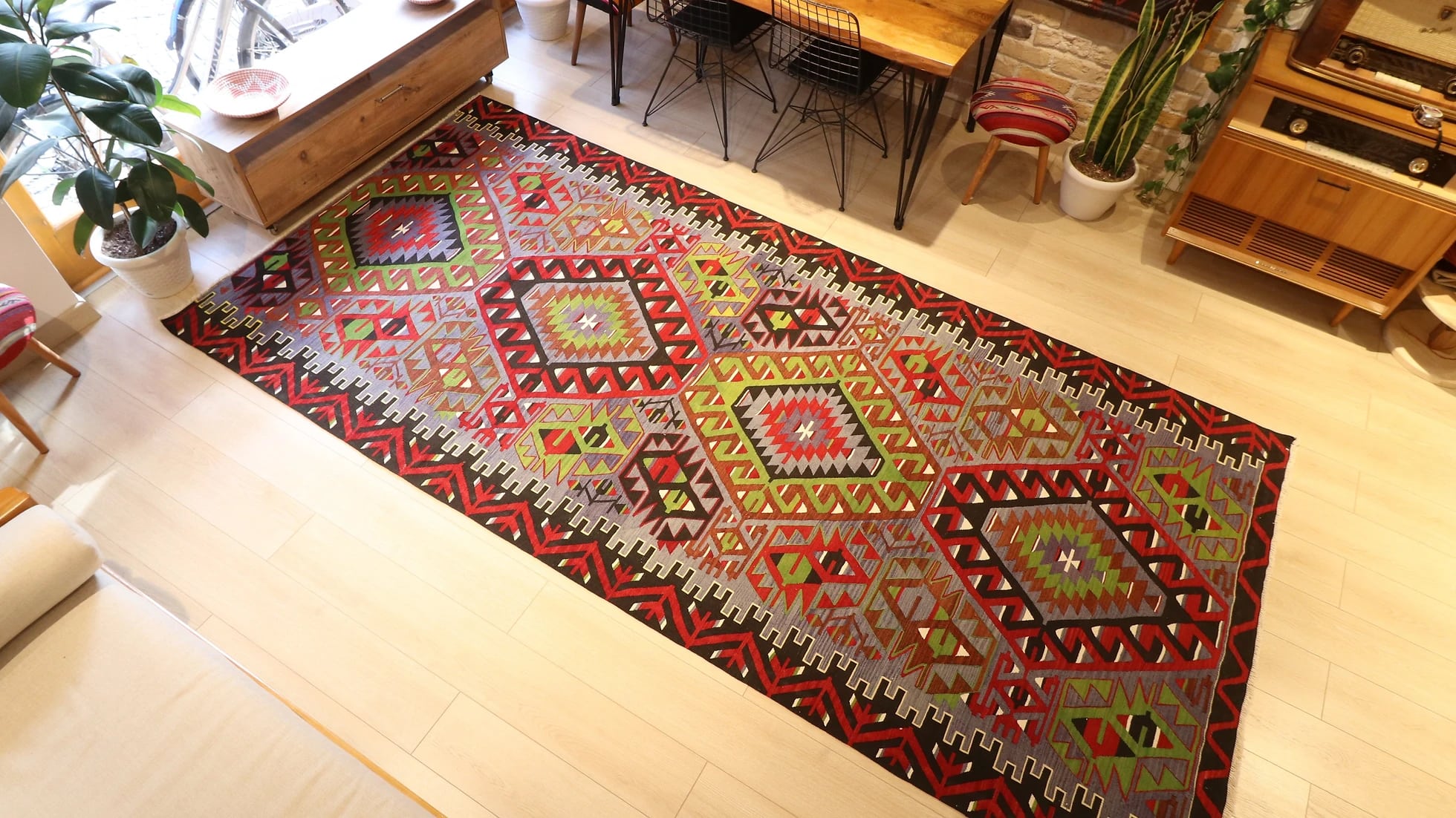 oversized vintage Oushak runner rug adorned with tribal motifs in rustic earth tones by Kilim Couture New York