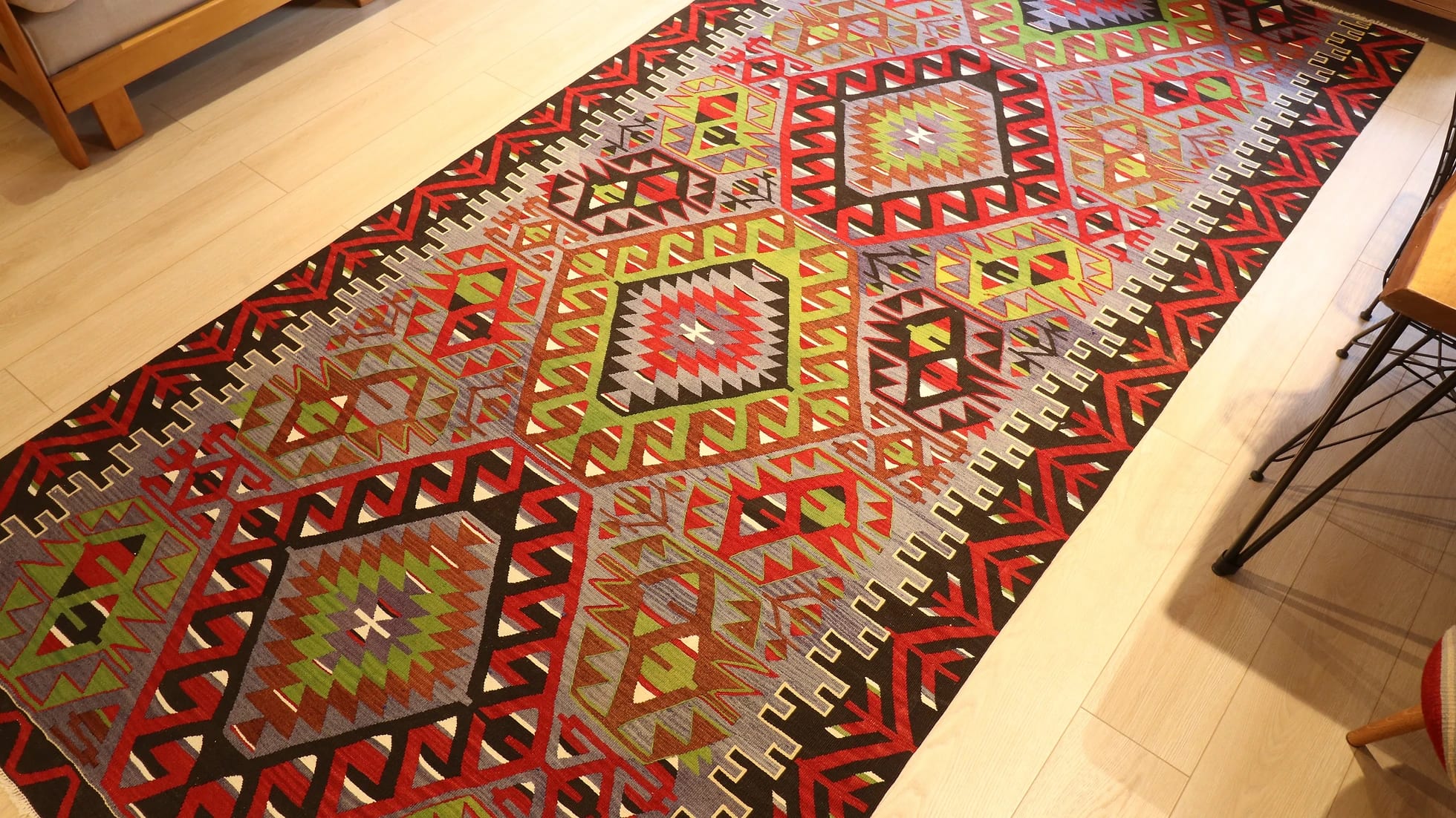 oversized vintage Oushak runner rug adorned with tribal motifs in rustic earth tones by Kilim Couture New York