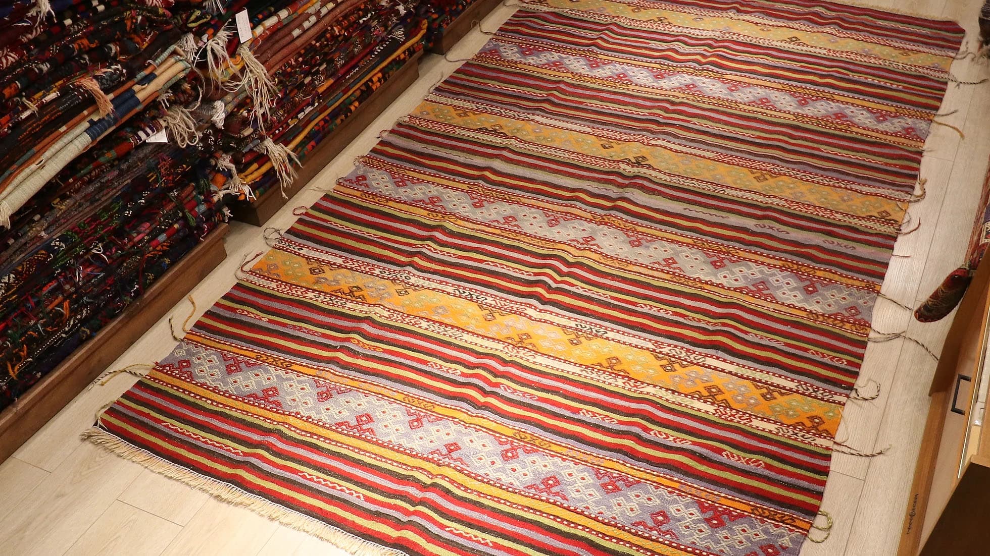 a true authentic and rare mid-century Turkish neutral kilim rug with long tassels in faded and muted pastel hues by Kilim Couture New York rug gallery