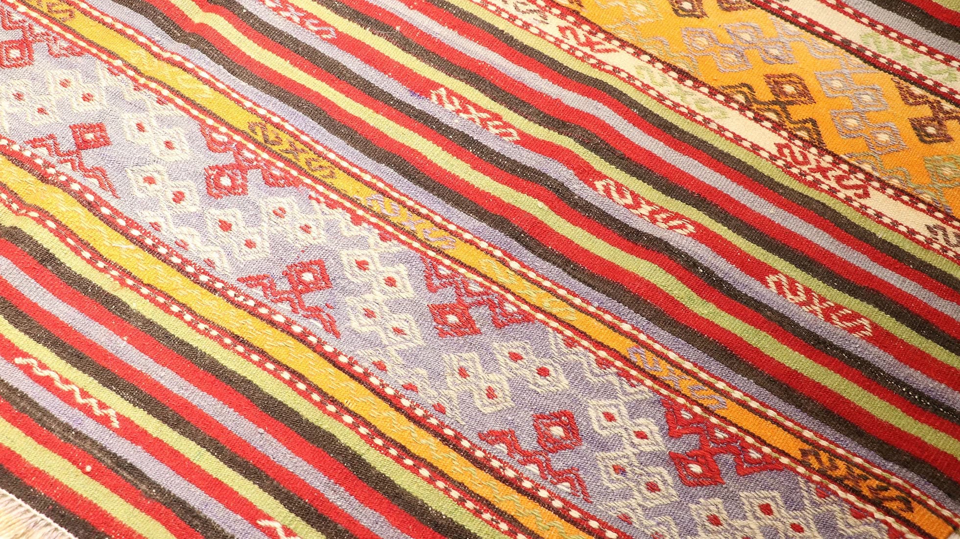a true authentic and rare mid-century Turkish neutral kilim rug with long tassels in faded and muted pastel hues by Kilim Couture New York rug gallery