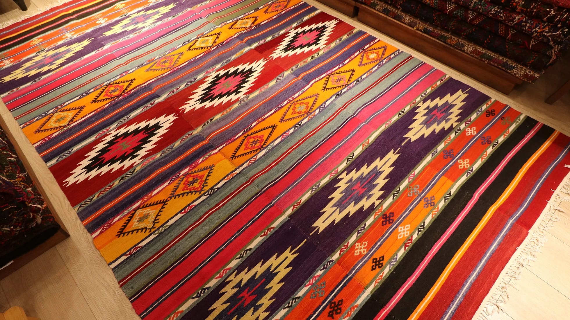 vibrant, vivid, and colorful striped Anatolian Turkish rug hand-knotted in the mid-century in traditional patterns